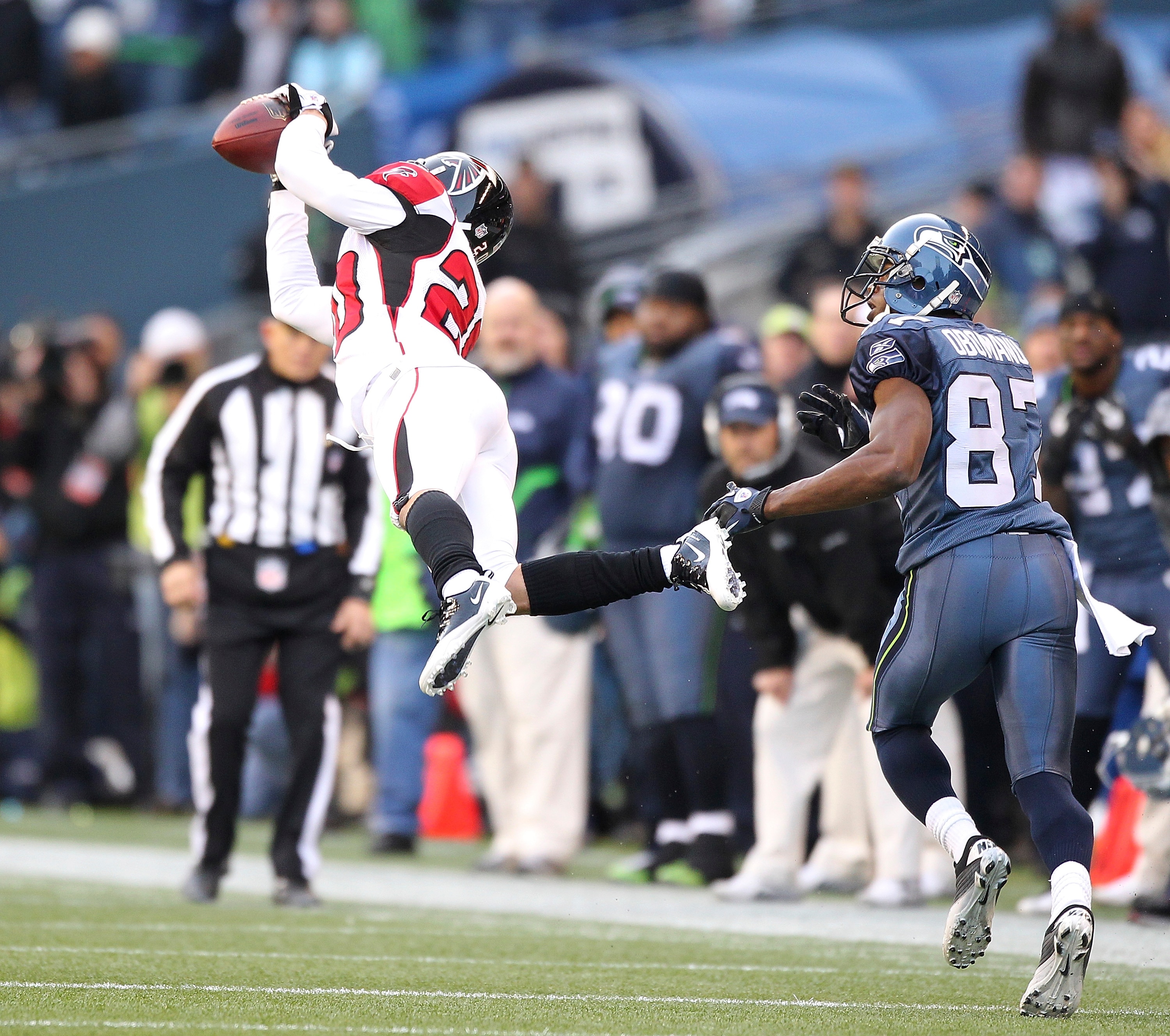 SEATTLE, WA - DECEMBER 19:  Brent Grimes #20 of the Atlanta Falcons makes an interception against Ben Obomanu #87 of the Seattle Seahawks at Qwest Field on December 19, 2010 in Seattle, Washington. The Falcons defeated the Seahawks 34-18. (Photo by Otto G
