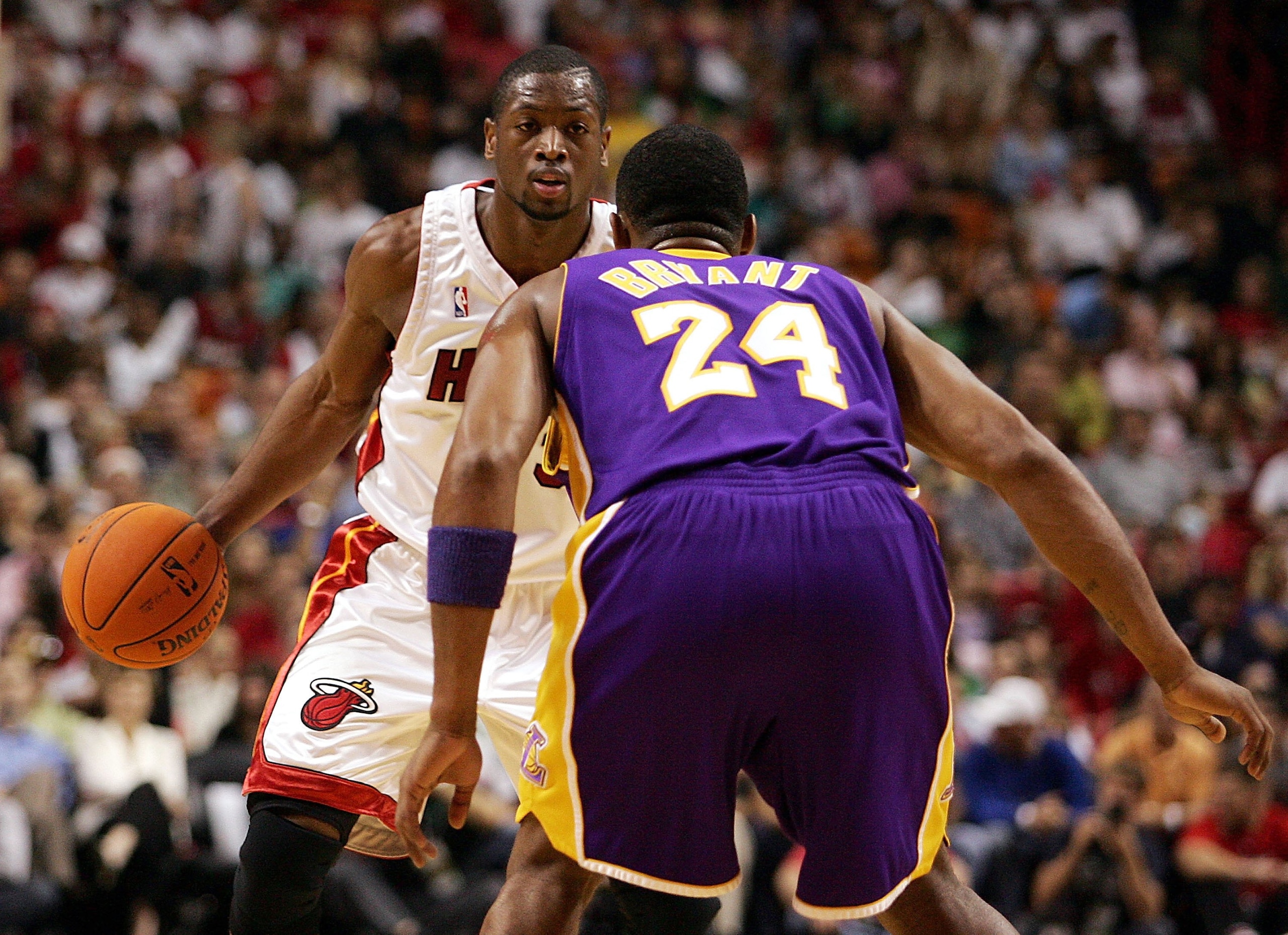 MIAMI - DECEMBER 25:  Guard Dwyane Wade #3 of the Miami Heat looks to drive against guard Kobe Bryant #24 of the Los Angeles Lakers on December 25, 2006 at the American Airlines Arena in Miami, Florida.  NOTE TO USER: User expressly acknowledges and agree