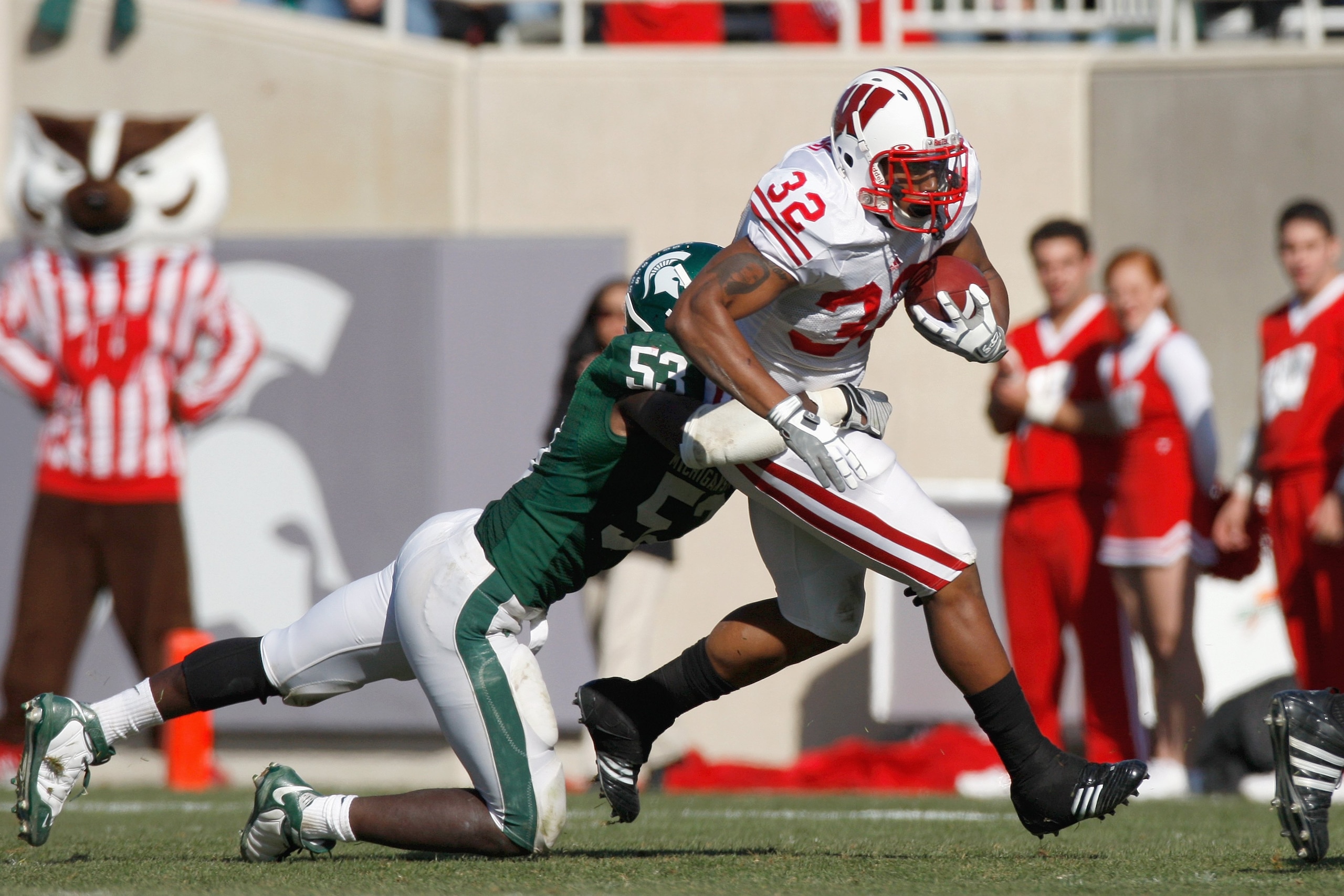 EAST LANSING - NOVEMBER 1: Eric Kossoris #32 of the Wisconsin Badgers carries the ball Greg Jones #53 of the Michigan State Spartans at Spartan Stadium on November 1, 2008 in East Lansing, Michigan. (Photo by: Gregory Shamus/Getty Images) EAST LANSING - NOVEMBER 1: Eric Kossoris #32 of the Wisconsin Badgers carries the ball Greg Jones #53 of the Michigan State Spartans at Spartan Stadium on November 1, 2008 in East Lansing, Michigan. (Photo by: Gregory Shamus/Getty Images)