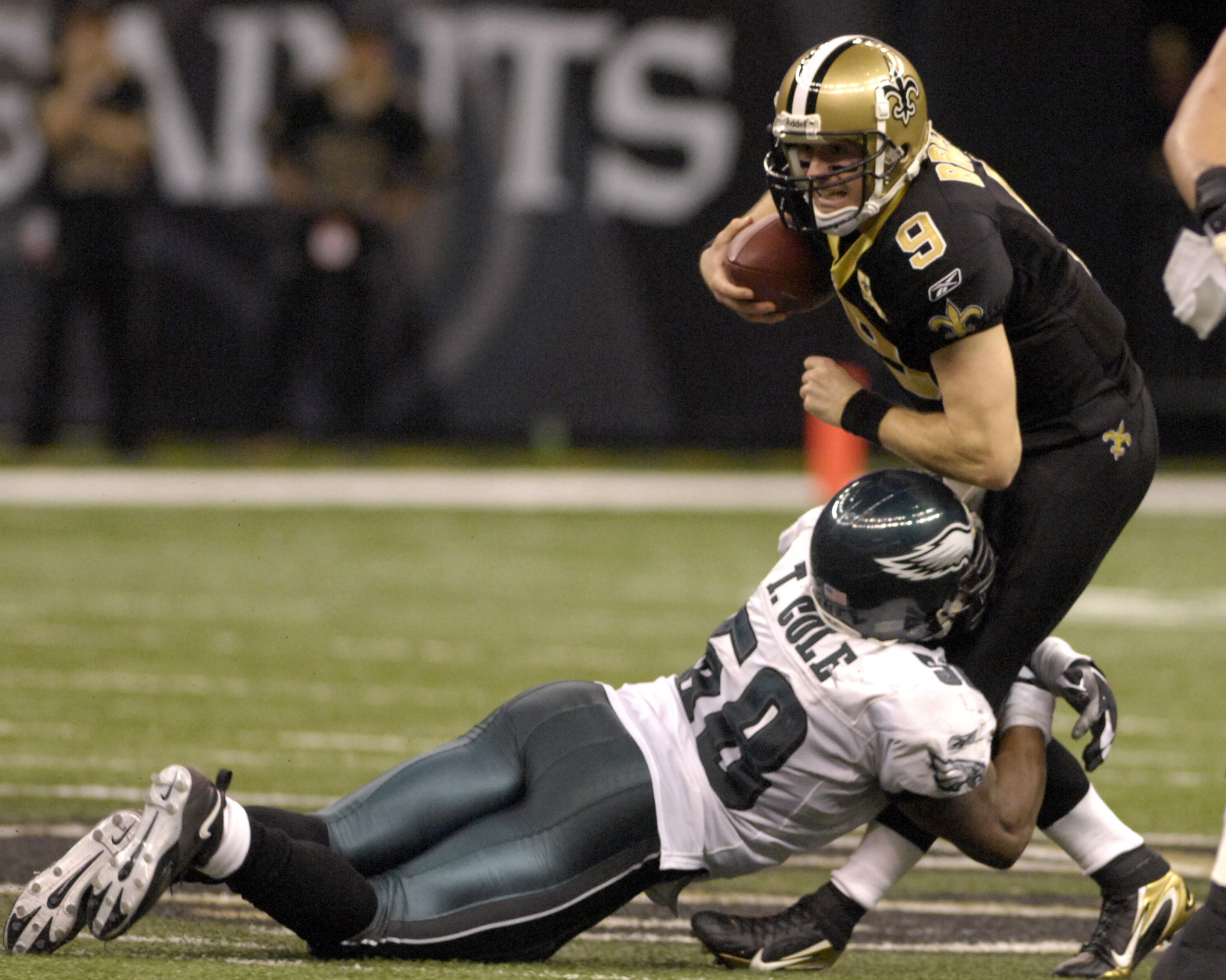 New Orleans Saints  quarterback Drew Brees dodges Philadelphia Eagles  linebacker Trent Cole during  an NFL NFC divisional playoff game on January 13, 2007 in the Superdome in New Orleans, Louisiana.  The Saints won 27 - 24.  (Photo by Al Messerschmidt/Ge