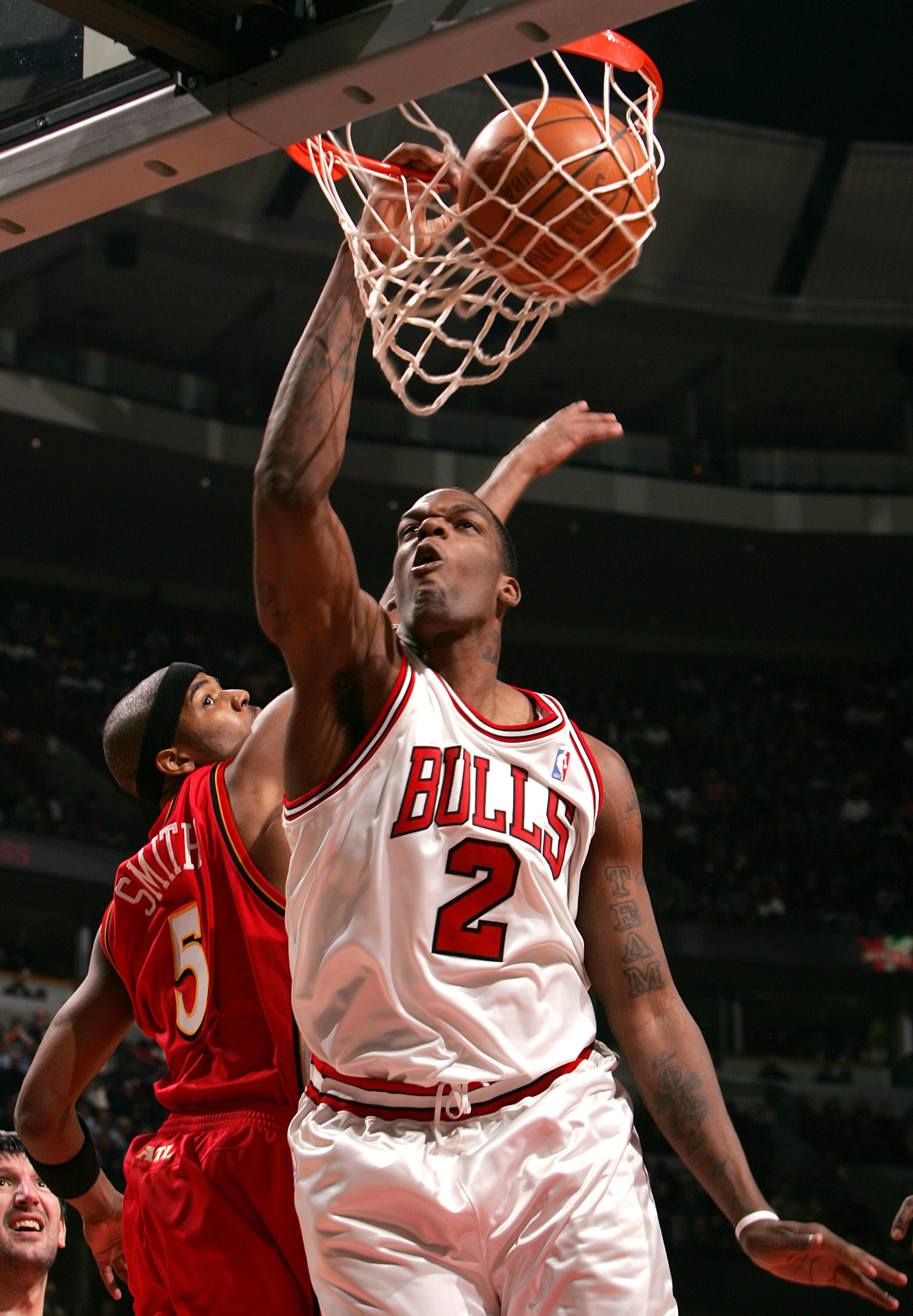 CHICAGO - JANUARY 21:  Eddy Curry #2 of the Chicago Bulls dunks the ball in front of Josh Smith #5 of the Atlanta Hawks on January 21, 2005 at the United Center in Chicago, Illinois. The Bulls defeated the Hawks 95-85. NOTE TO USER: User expressly acknowl