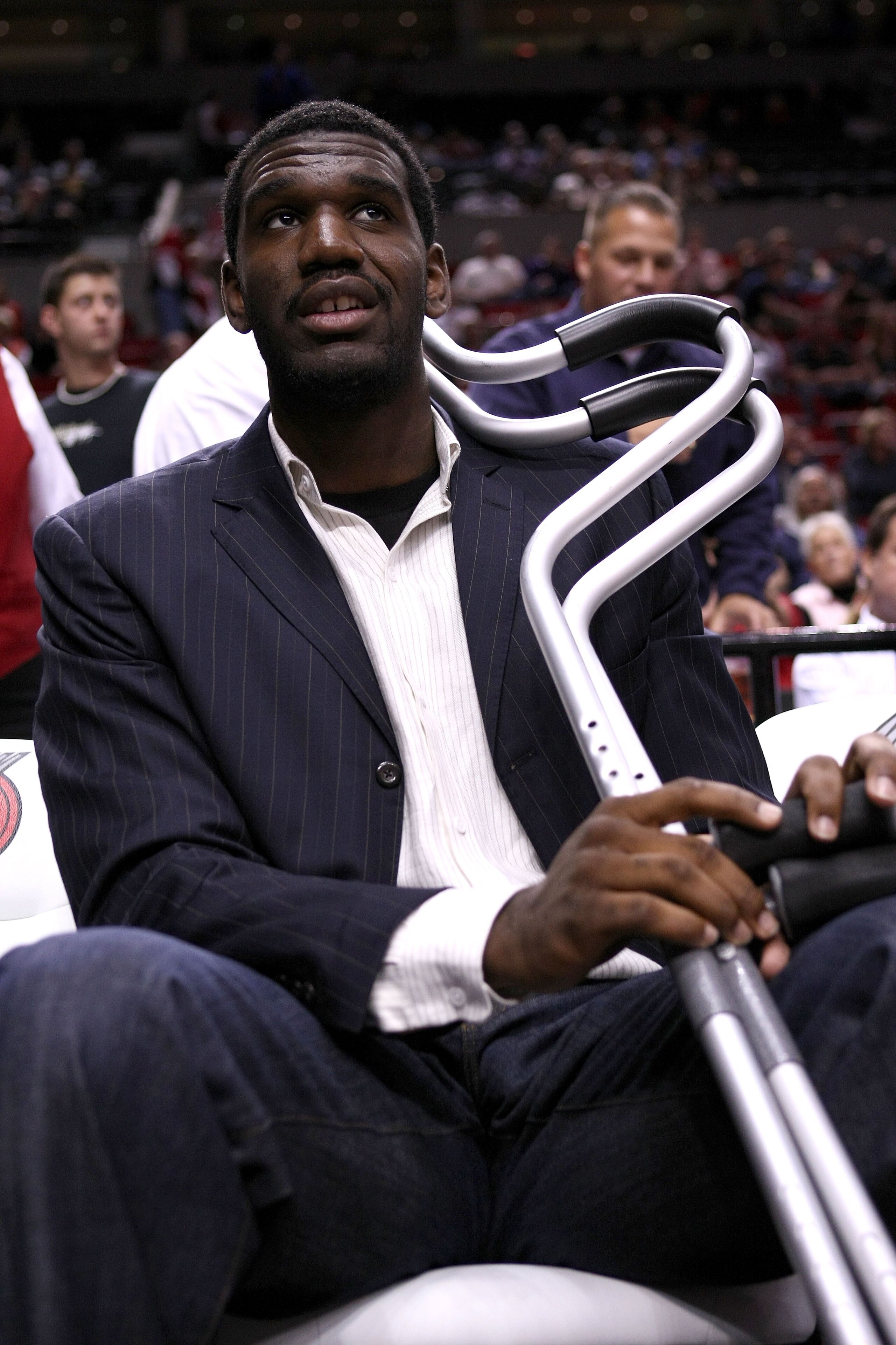 PORTLAND, OR - OCTOBER 10:  Greg Oden #52 of the Portland Trail Blazers, who is out for the season after under going micro fracture surgery in his knee, sits on the bench to watch a pre-season game against the Los Angeles Clippers at the Rose Garden on Oc