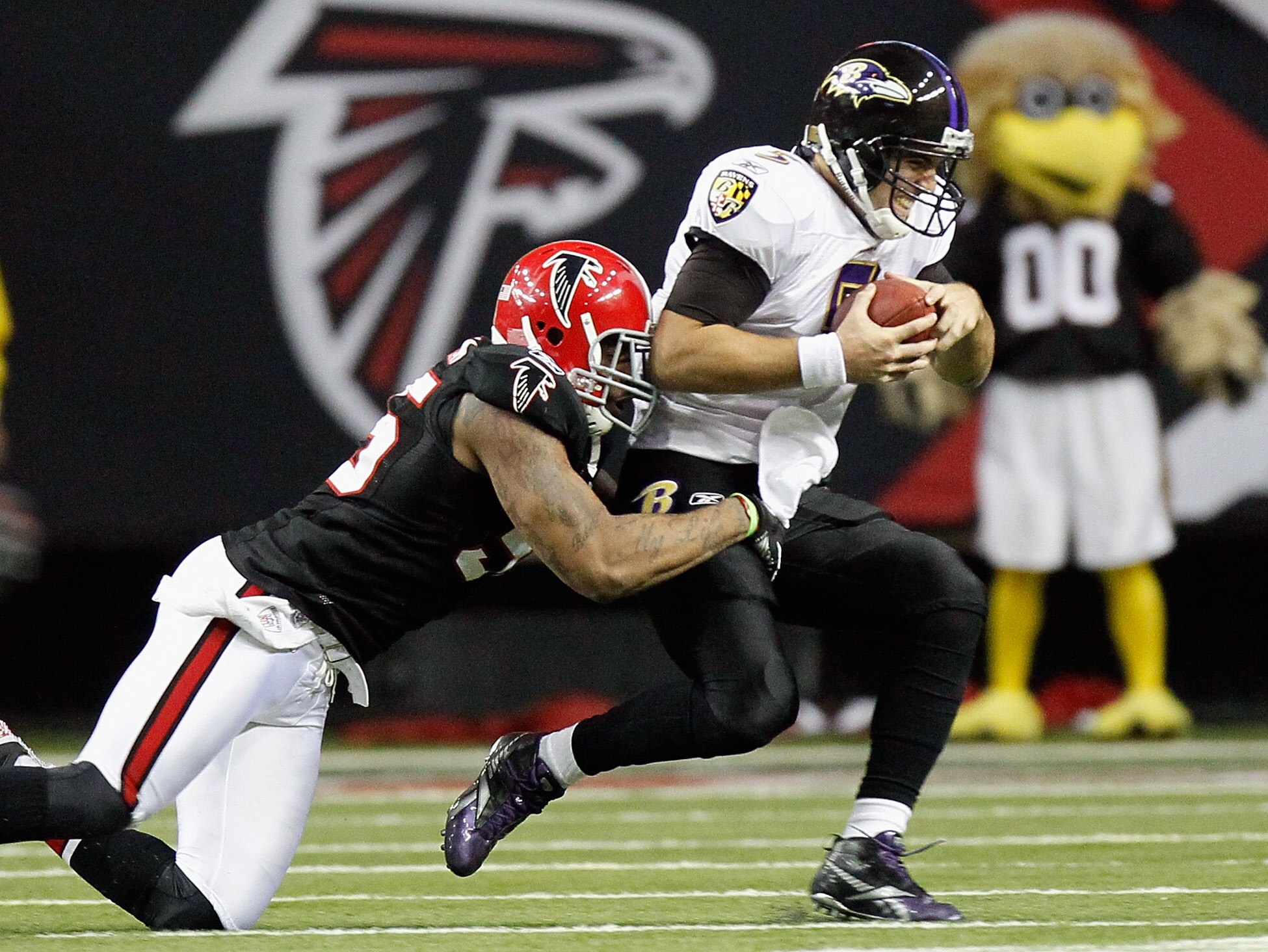 ATLANTA - NOVEMBER 11:  John Abraham #55 of the Atlanta Falcons sacks quarterback Joe Flacco #5 of the Baltimore Ravens at Georgia Dome on November 11, 2010 in Atlanta, Georgia.  (Photo by Kevin C. Cox/Getty Images)