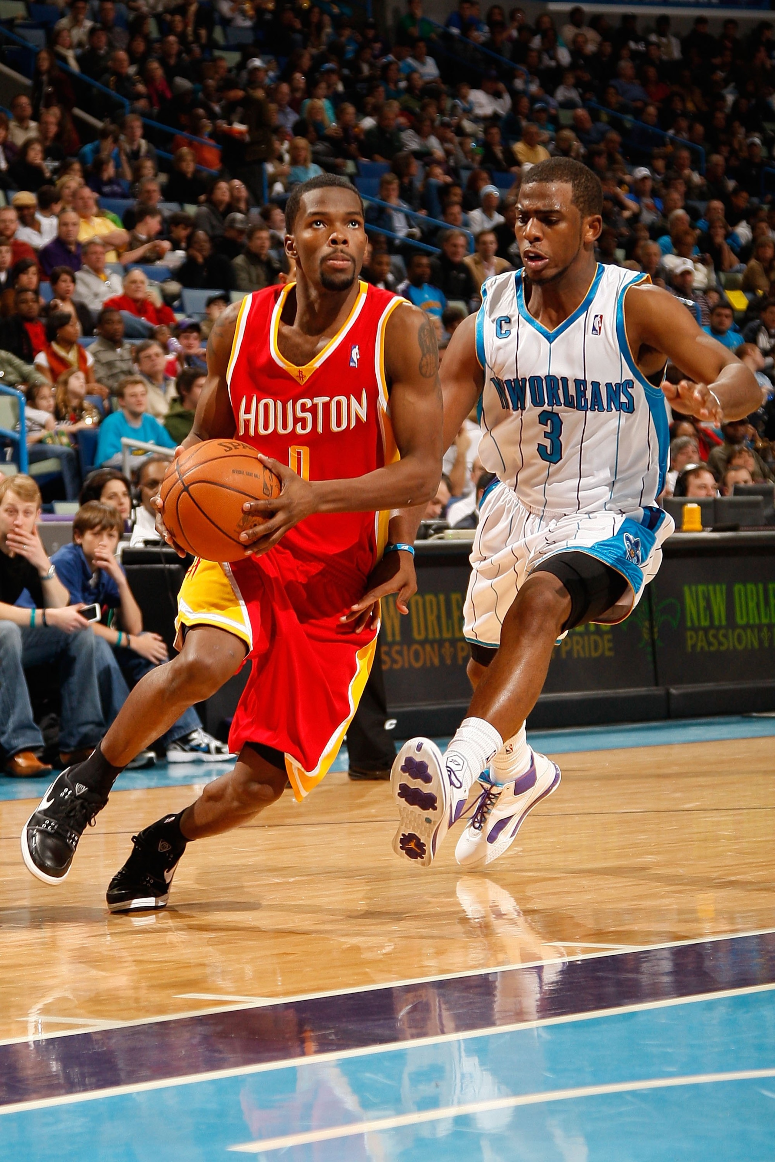 NEW ORLEANS - JANUARY 02:  Aaron Brooks #0 of the Houston Rockets drives the ball around Chris Paul #3 of the New Orleans Hornets at the New Orleans Arena on January 2, 2010 in New Orleans, Louisiana.  NOTE TO USER: User expressly acknowledges and agrees