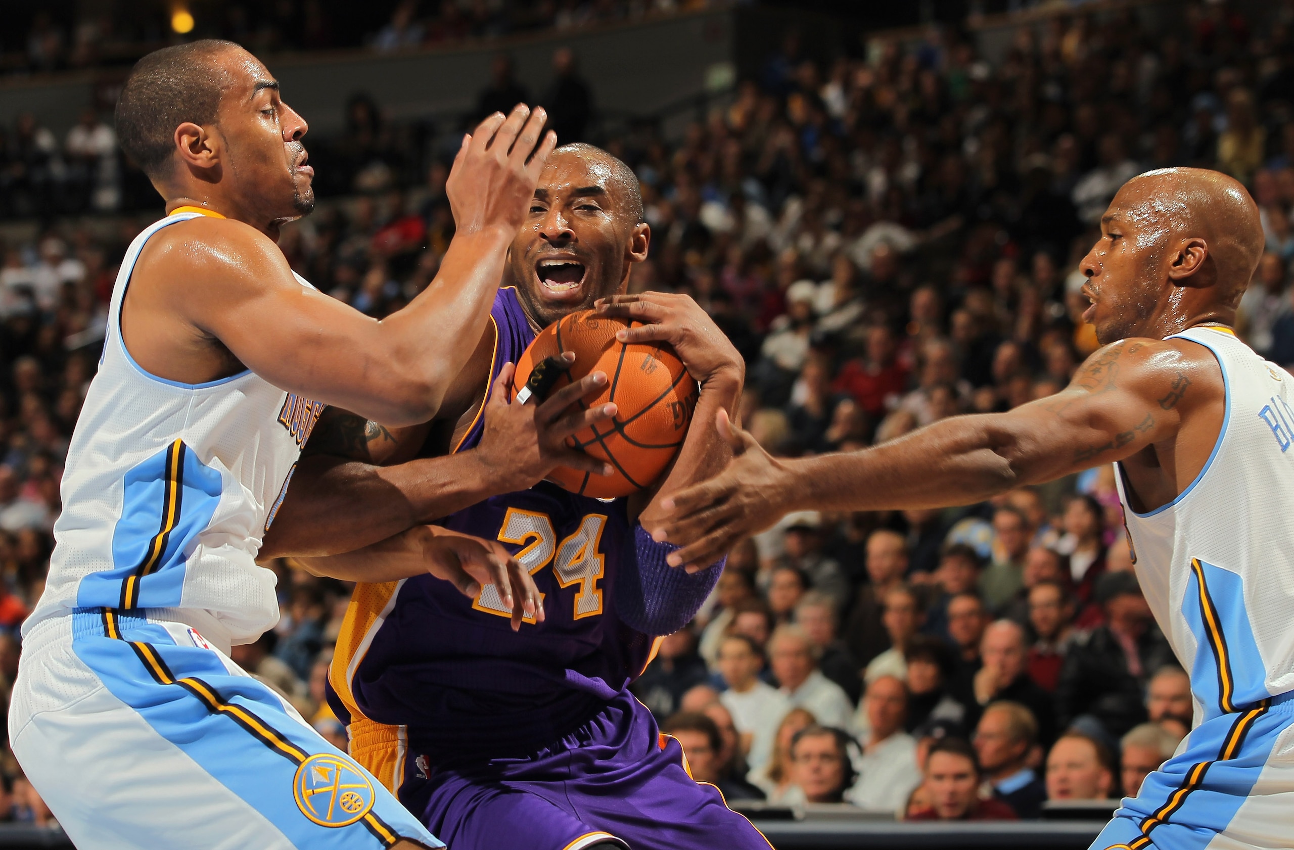 DENVER - NOVEMBER 11:  Kobe Bryant #24 of the Los Angeles Lakers tries to drive between Arron Afflalo #6 and Chauncey Billups #1 of the Denver Nuggets at Pepsi Center on November 11, 2010 in Denver, Colorado. NOTE TO USER: User expressly acknowledges and