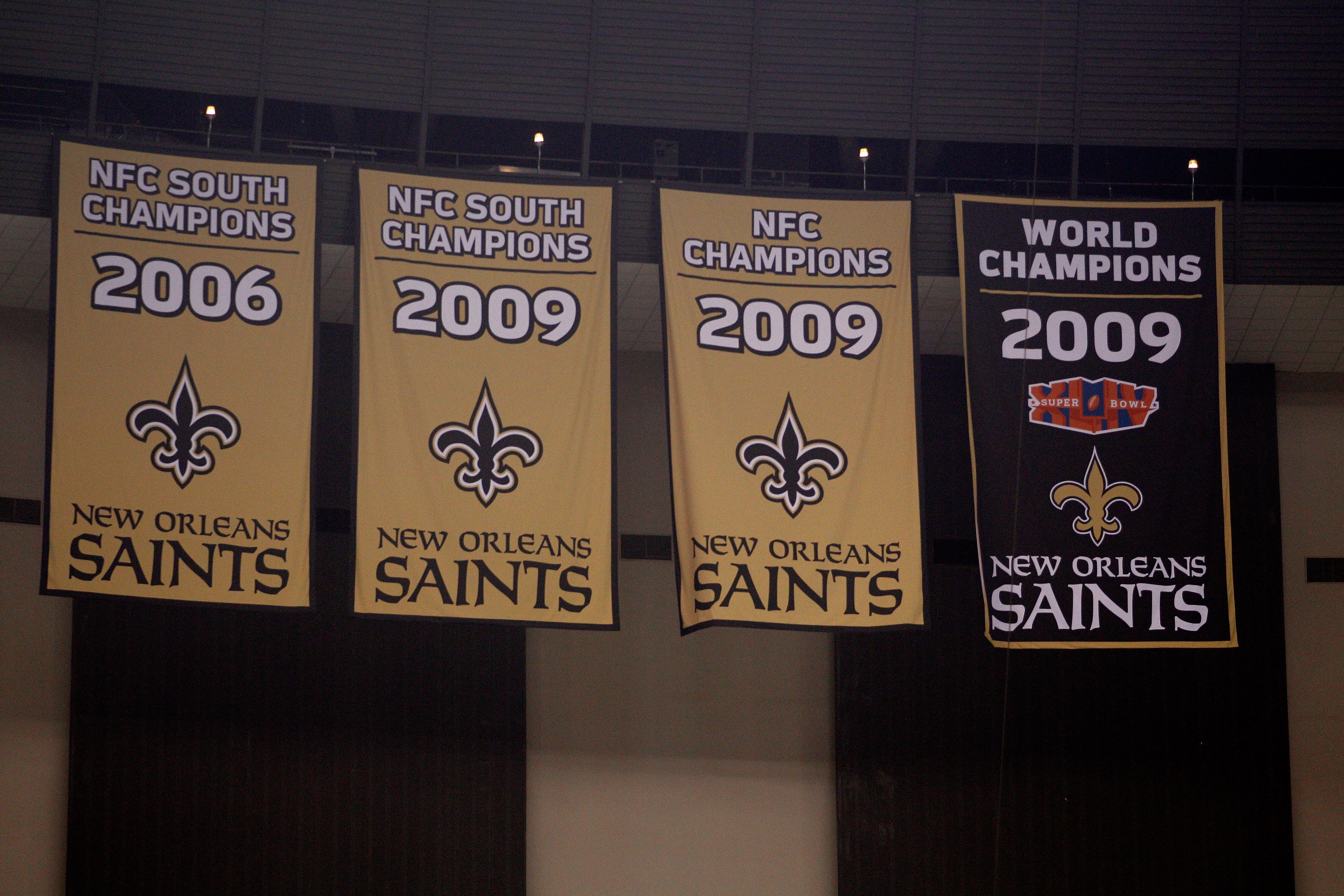 NEW ORLEANS - SEPTEMBER 09:  The banners representing achievements of the New Orleans Saints, including the newly unveiled 2009 Super Bowl World Champions banner, hang above the fans in the upper deck during the Saints game against the Minnesota Vikings a