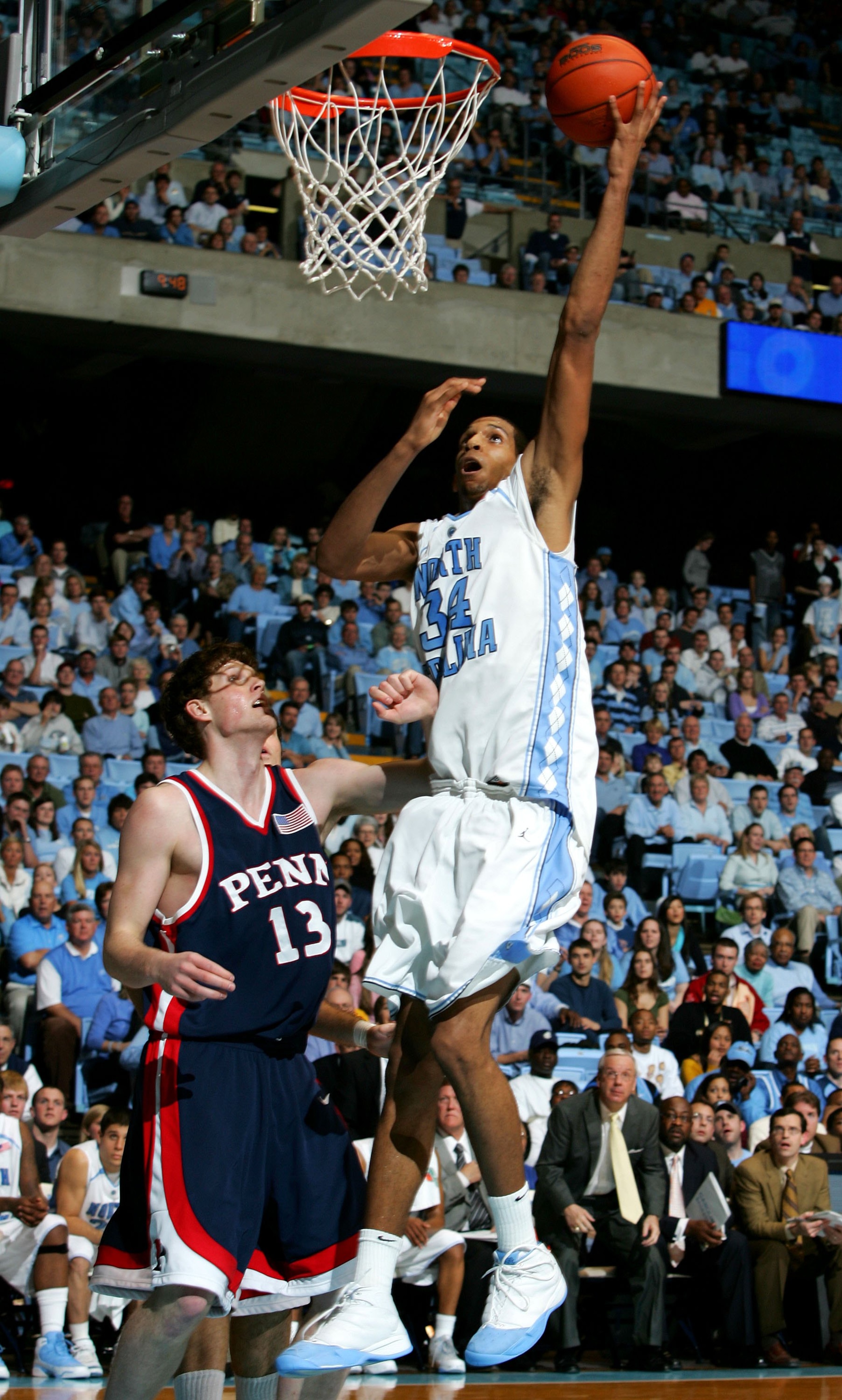 CHAPEL HILL, NC - JANUARY 03:  Andreas Schreiber #13 of the Pennsylvania Quakers watches as Brandan Wright #34 of the University of North Carolina Tar Heels goes to the basket on January 3, 2006 at the Dean Smith Center in Chapel Hill, North Carolina.  (P