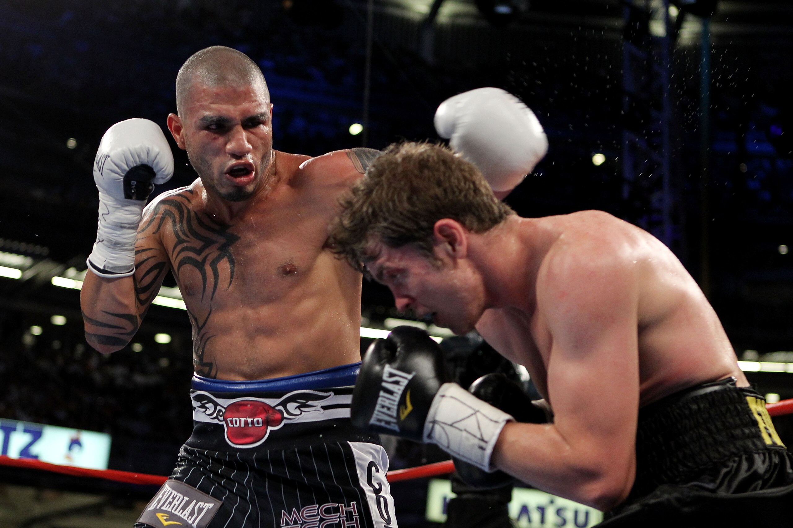 NEW YORK - JUNE 05:  (L-R) Miguel Cotto of Puerto Rico throws a left to the face of Yuri Foreman during the WBA world super welterweight title fight on June 5, 2010 at Yankee Stadium in the Bronx borough of New York City.  (Photo by Al Bello/Getty Images)