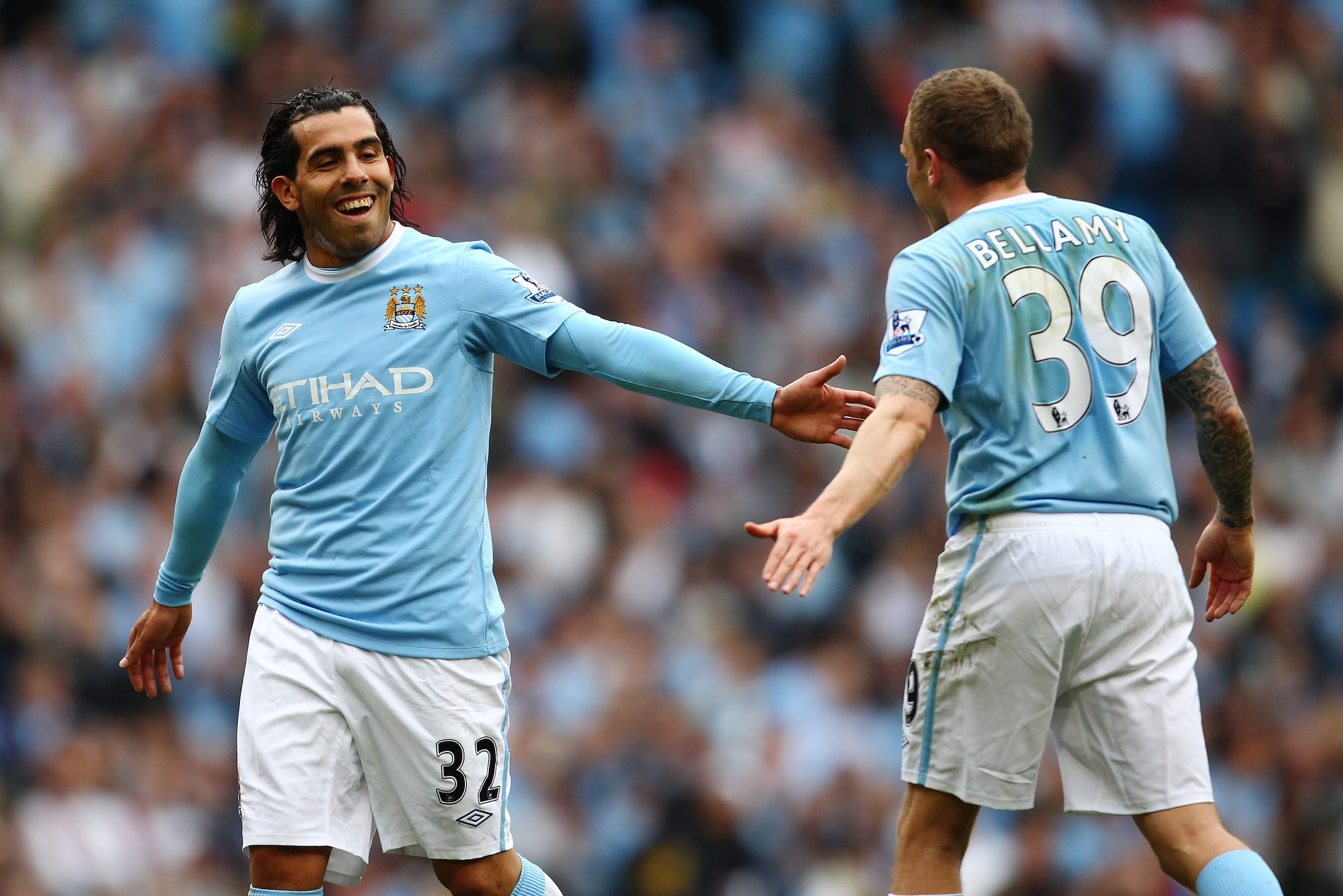 MANCHESTER, ENGLAND - APRIL 11:  Carlos Tevez of Manchester City and Craig Bellamy smile during the Barclays Premier League match between Manchester City and Birmingham City at Eastlands, City of Manchester Stadium on April 11, 2010 in Manchester, England