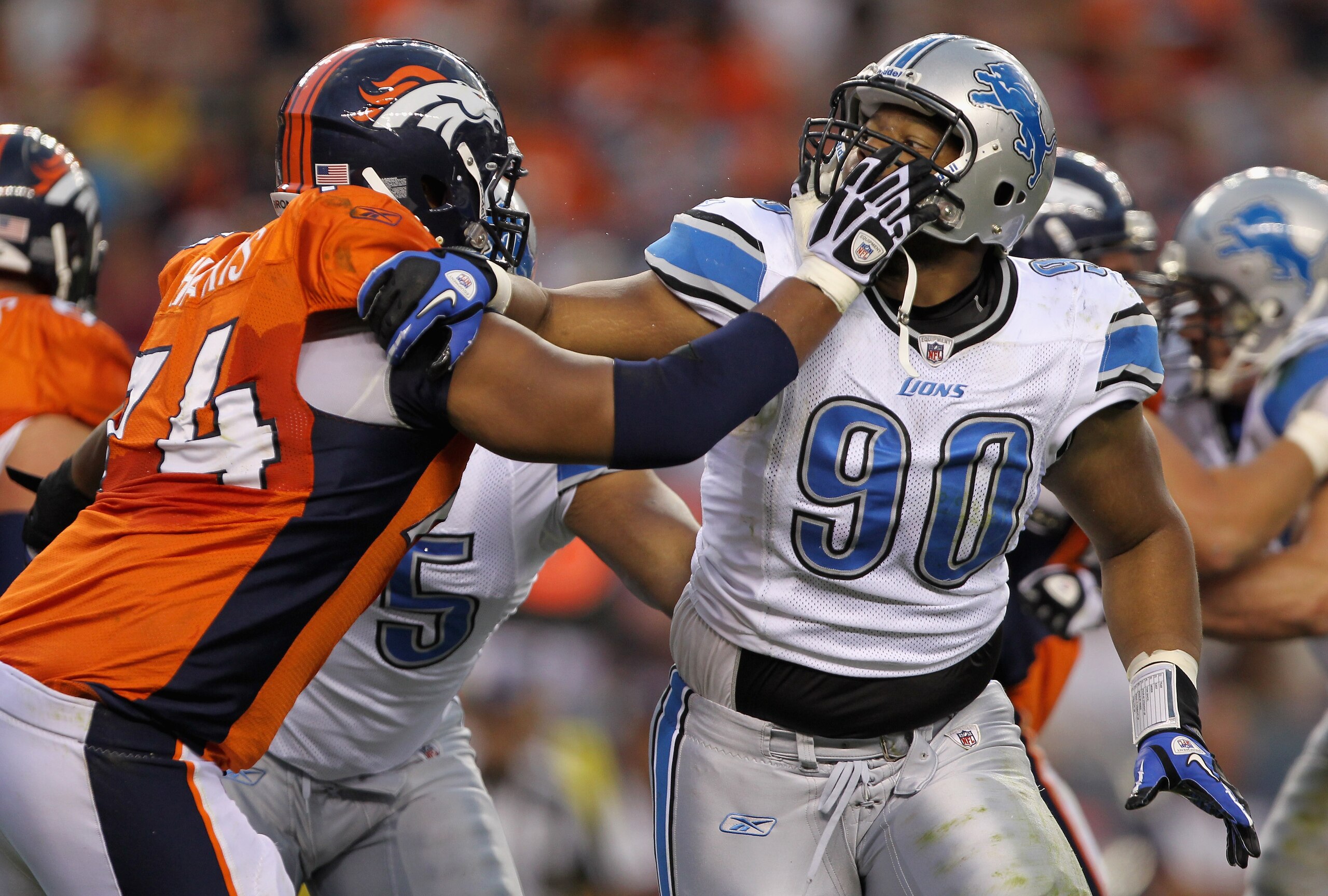 DENVER - AUGUST 21:  Defensive tackle Ndamukong Suh #90 of the Detroit Lions battles the blocking of offensive tackle Ryan Harris #74 of the Denver Broncos during preseason NFL action at INVESCO Field at Mile High on August 21, 2010 in Denver, Colorado.