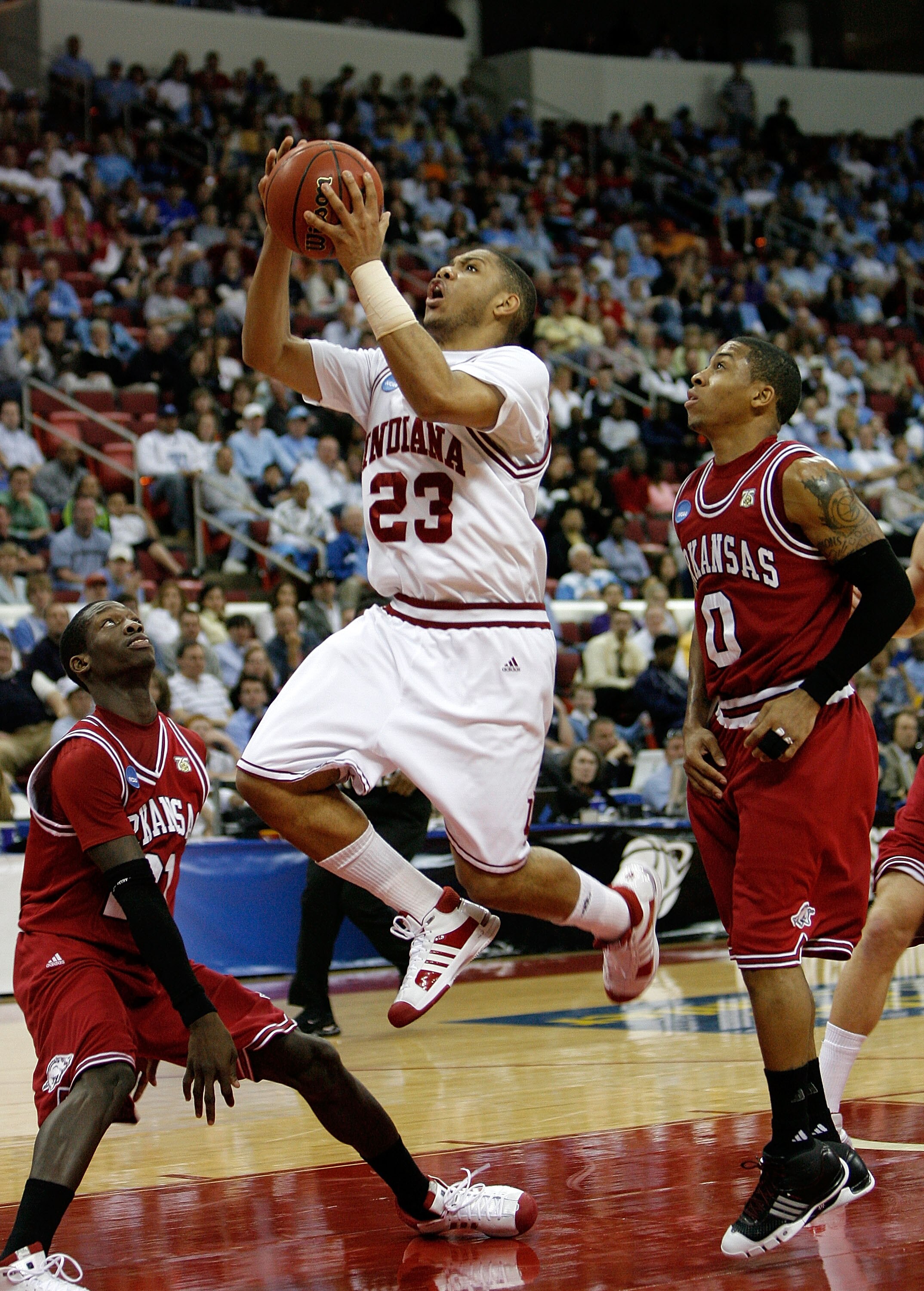 RALEIGH, NC - MARCH 21:  Eric Gordon #23 of the Indiana Hoosiers drives through Patrick Beverley #21 and Gary Ervin #0 of the Arkansas Razorbacks during the first round of the 2008 NCAA Men's Basketball Tournament East Regional at RBC Center March 21, 200