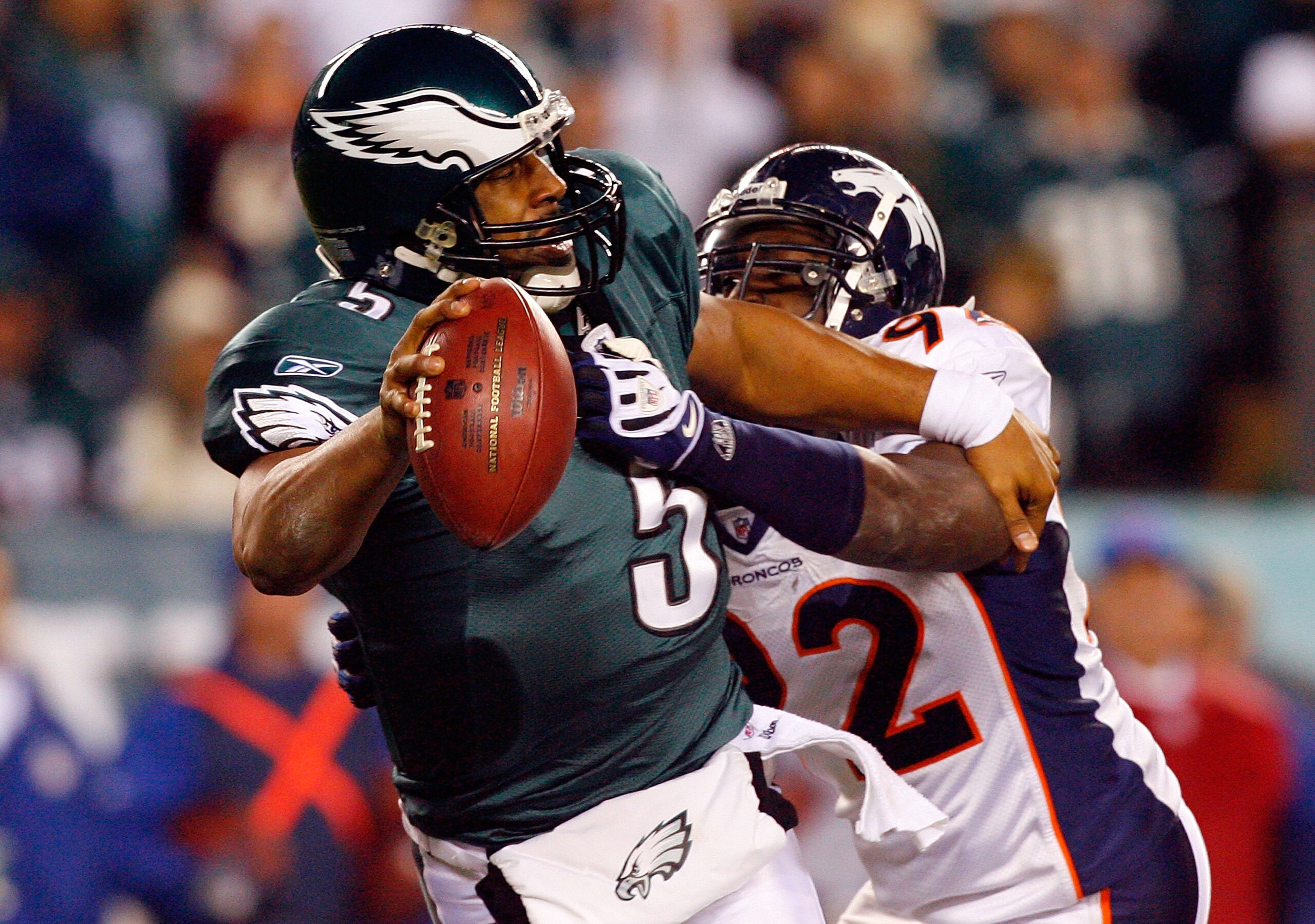 PHILADELPHIA - DECEMBER 27:  Donovan McNabb #5 of the Philadelphia Eagles is pressured by Elvis Dumervil #92 of the Denver Broncos on December 27, 2009 at Lincoln Financial Field in Philadelphia, Pennsylvania. The Eagles defeated the Broncos 30-27.  (Phot