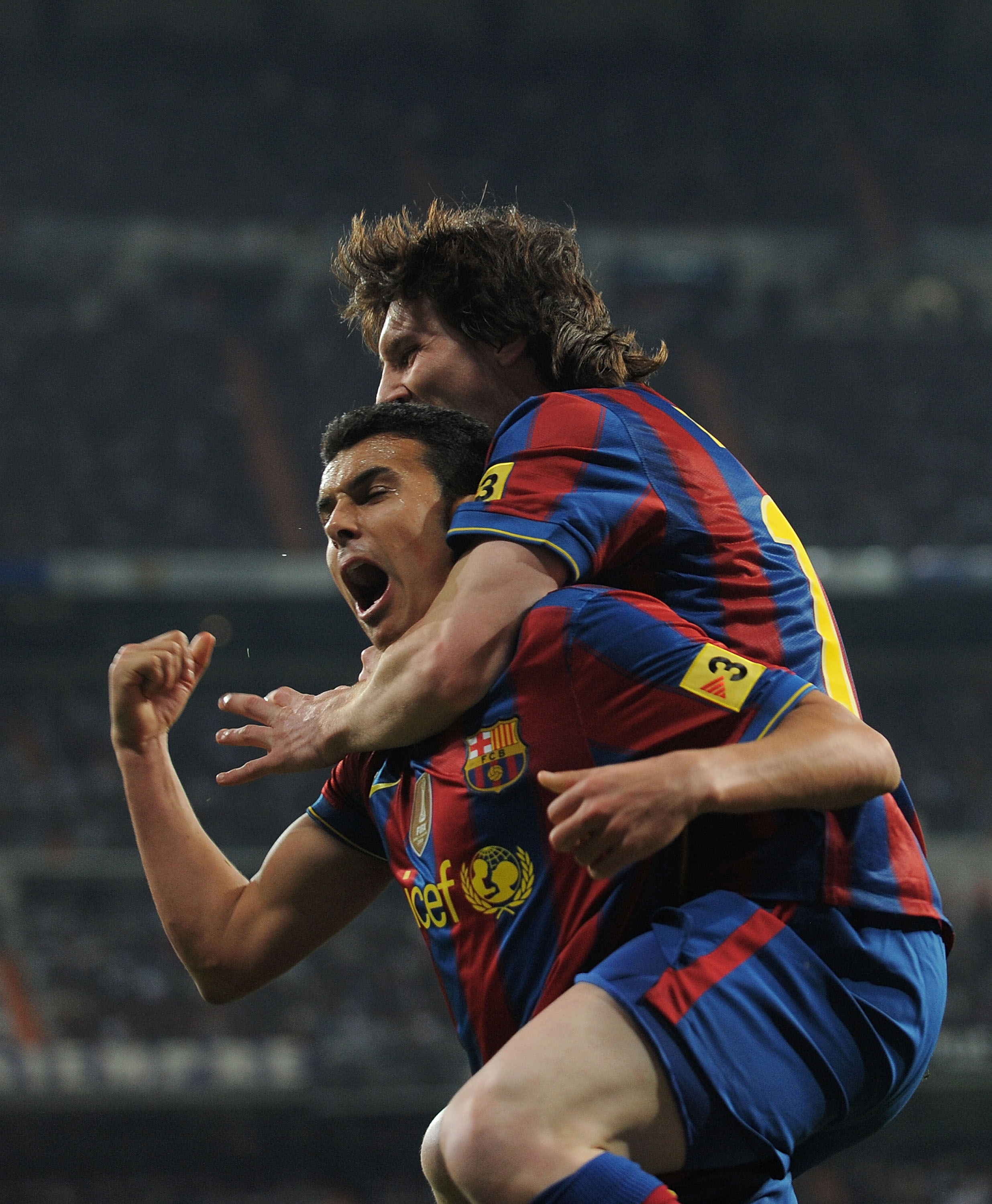 MADRID, SPAIN - APRIL 10:  Pedro Rodriguez of Barcelona celebrates beside Lionel Messi after scoring Barcelona's second goal during the La Liga match between Real Madrid and Barcelona at the Estadio Santiago Bernabeu on April 10, 2010 in Madrid, Spain.  (