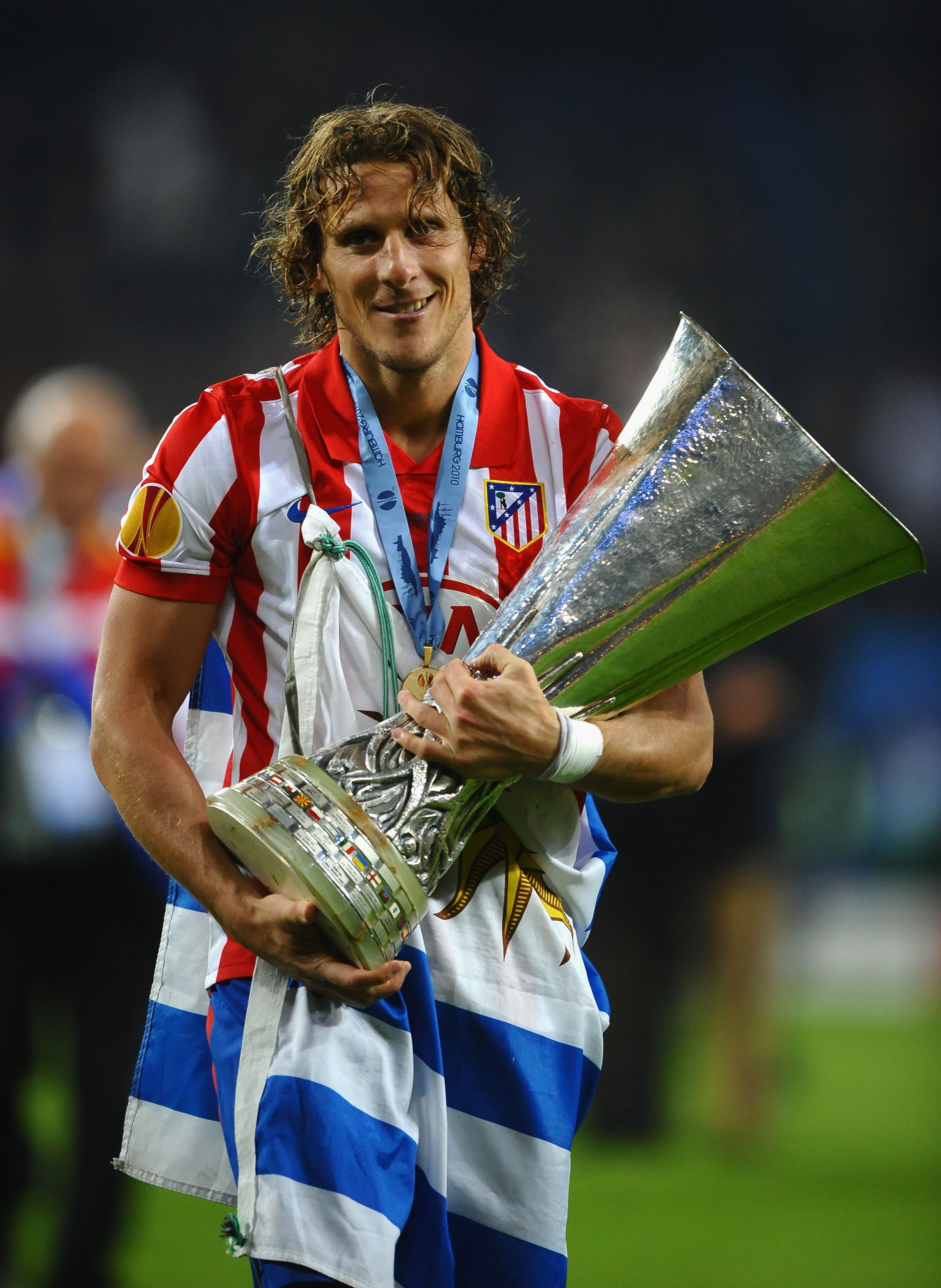 HAMBURG, GERMANY - MAY 12: Diego Forlan of Atletico Madrid holds the UEFA Europa League trophy following his team's victory after extra time at the end of the UEFA Europa League final match between Atletico Madrid and Fulham at HSH Nordbank Arena on May 1 HAMBURG, GERMANY - MAY 12: Diego Forlan of Atletico Madrid holds the UEFA Europa League trophy following his team's victory after extra time at the end of the UEFA Europa League final match between Atletico Madrid and Fulham at HSH Nordbank Arena on May 1