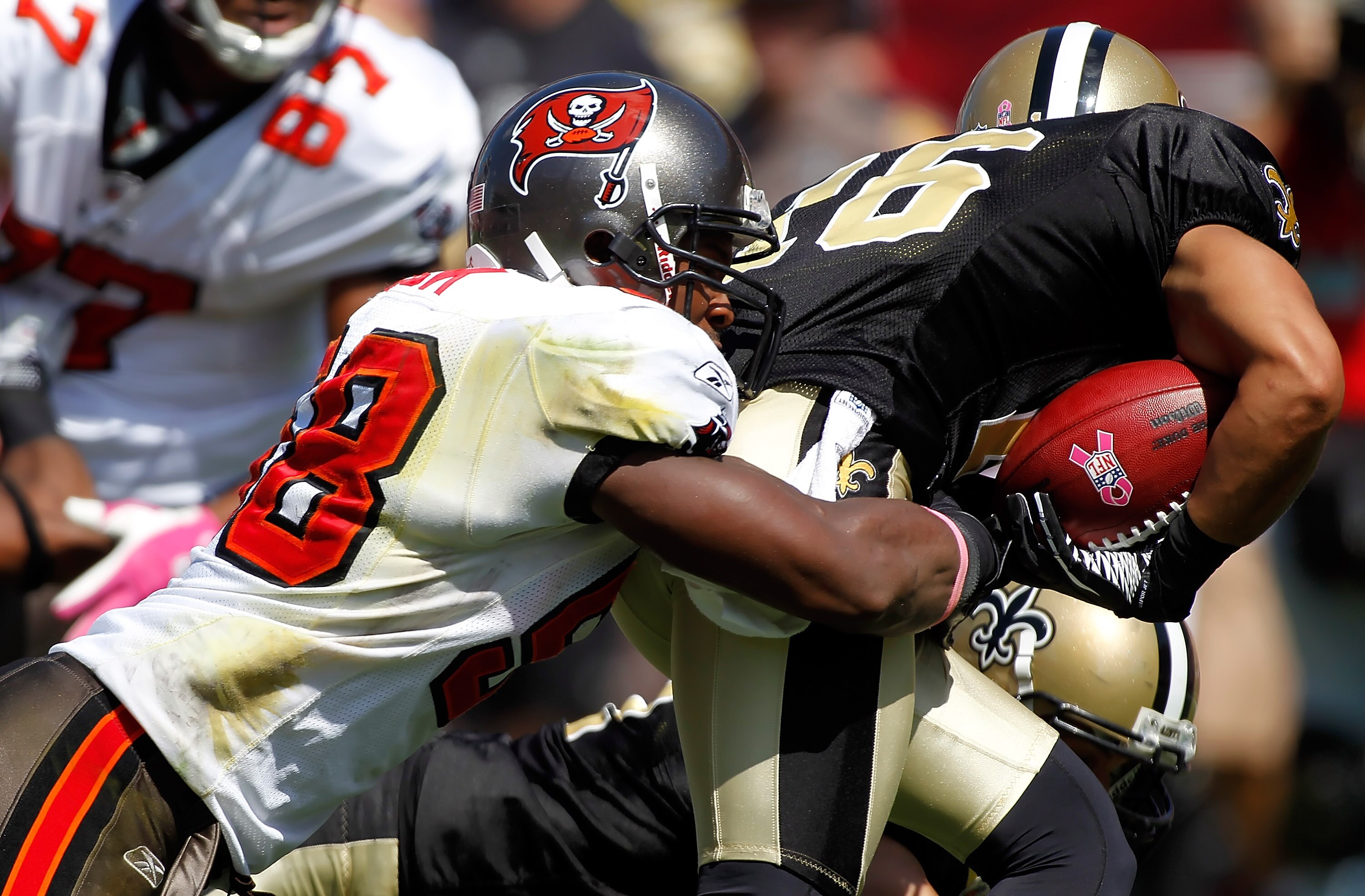 TAMPA, FL - OCTOBER 17:  Linebacker Quincy Black #58 of the Tampa Bay Buccaneers tackles Lance Moore #16 of the New Orleans Saints on a return during the game at Raymond James Stadium on October 17, 2010 in Tampa, Florida.  (Photo by J. Meric/Getty Images