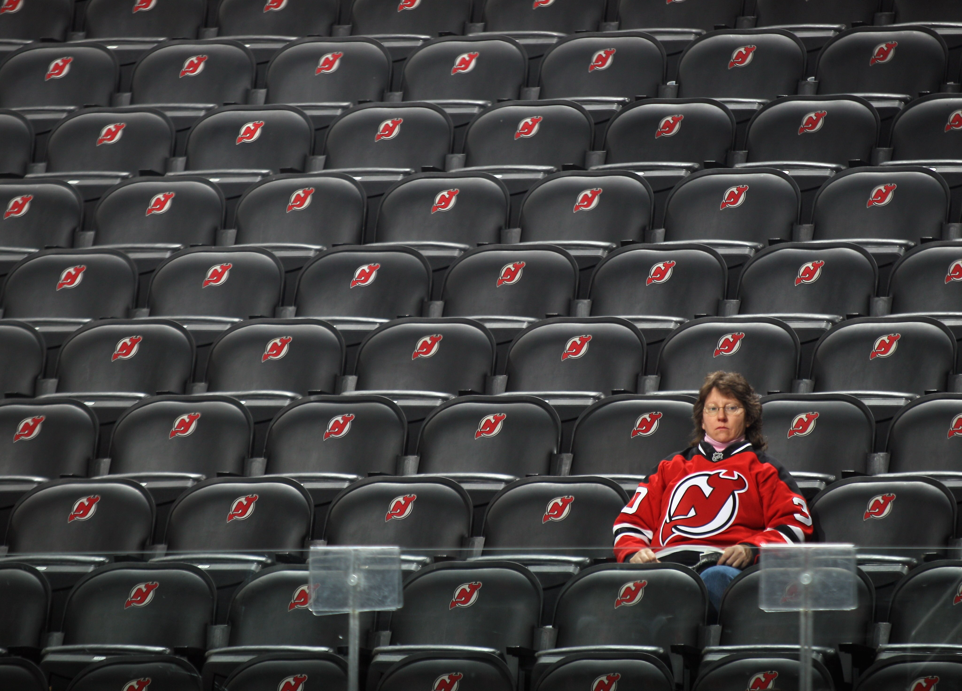 NEWARK, NJ - DECEMBER 17: A fan watches warmups prior to the game between the New Jersey Devils and the Nashville Predators at the Prudential Center on December 17, 2010 in Newark, New Jersey.  (Photo by Bruce Bennett/Getty Images)
