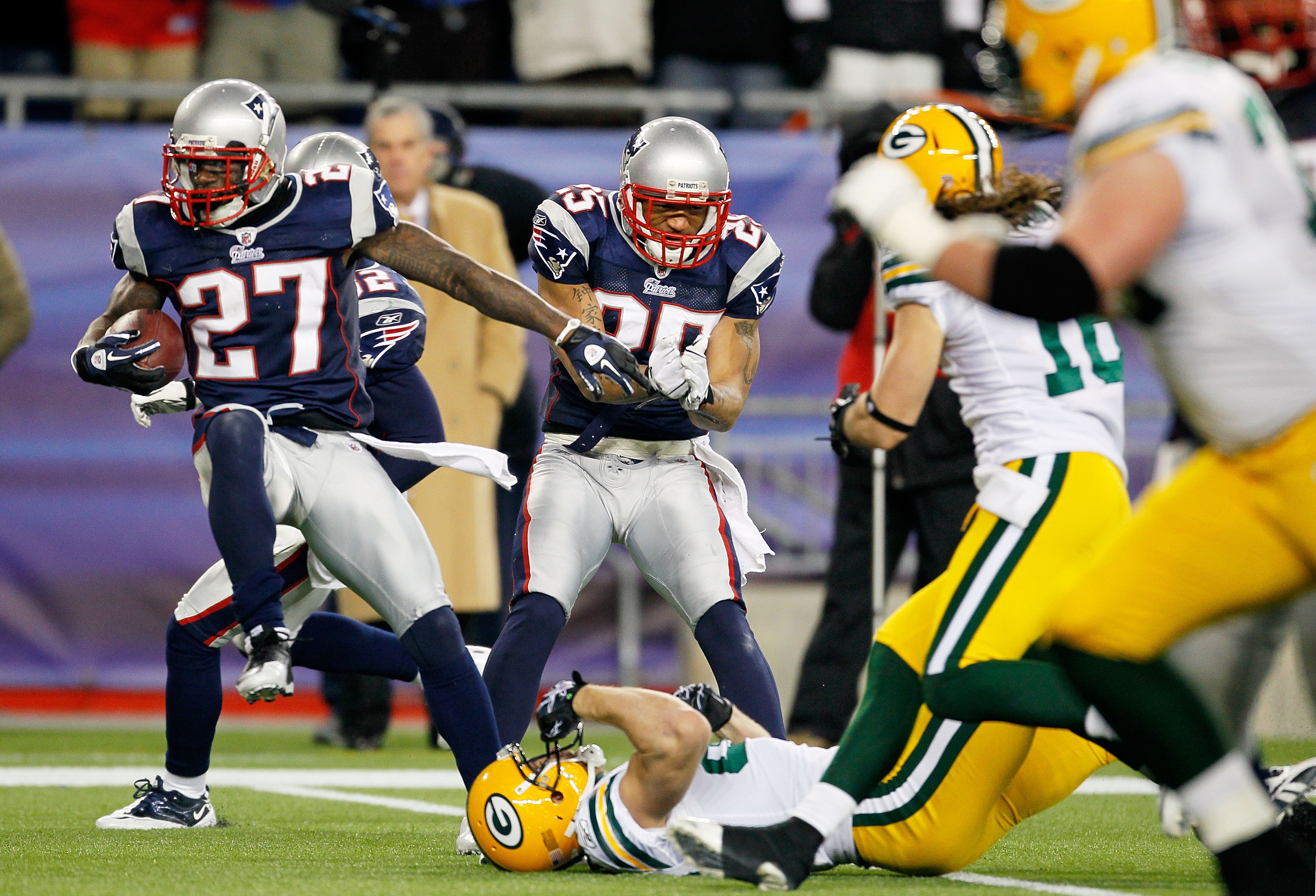 FOXBORO, MA - DECEMBER 19:  Cornerback Kyle Arrington #27 of the New England Patriots scores a touchdown after intercepting the ball and running 36 yards against the Green Bay Packers during the third quarter of the game at Gillette Stadium on December 19