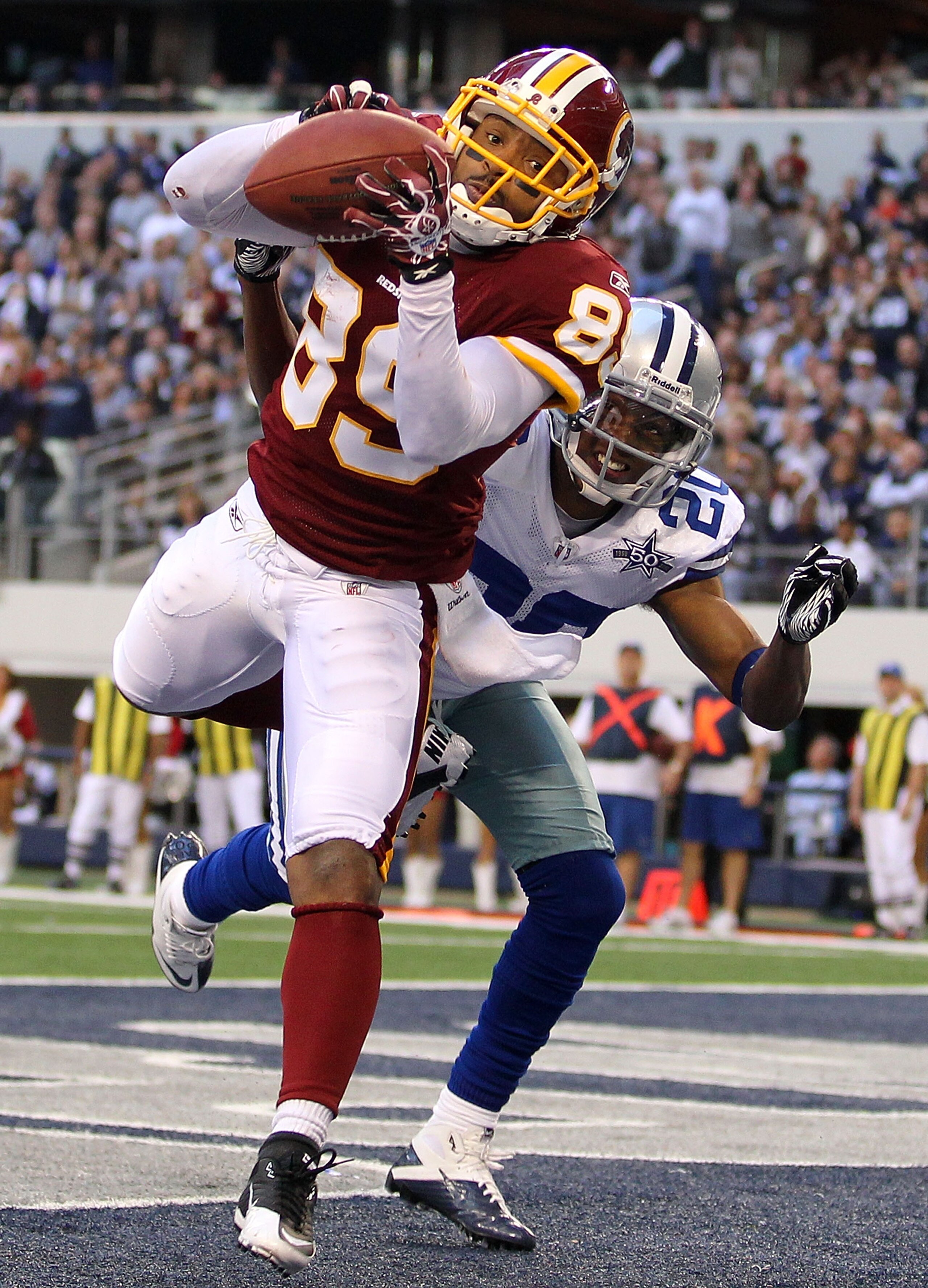 ARLINGTON, TX - DECEMBER 19: Wide receiver Santana Moss #89 of the Washington Redskins makes a touchdown pass reception against Alan Ball #20 of the Dallas Cowboys at Cowboys Stadium on December 19, 2010 in Arlington, Texas. (Photo by Ronald Martinez/Ge ARLINGTON, TX - DECEMBER 19: Wide receiver Santana Moss #89 of the Washington Redskins makes a touchdown pass reception against Alan Ball #20 of the Dallas Cowboys at Cowboys Stadium on December 19, 2010 in Arlington, Texas. (Photo by Ronald Martinez/Ge