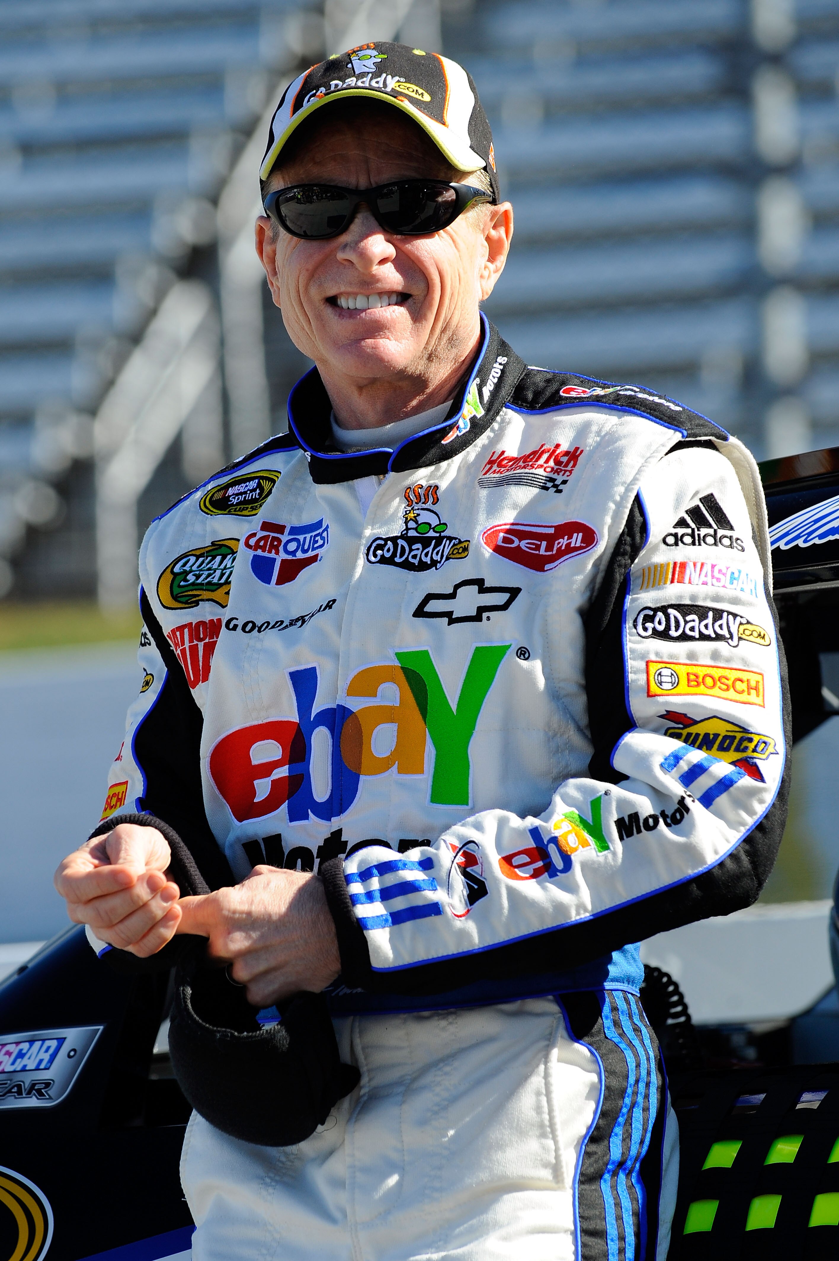 MARTINSVILLE, VA - OCTOBER 22:  Mark Martin, driver of the #5 ebay Motors/GoDaddy.com Chevrolet, stands next to his car on pit road during qualifying for the NASCAR Sprint Cup Series TUMS Fast Relief 500 at Martinsville Speedway on October 22, 2010 in Mar