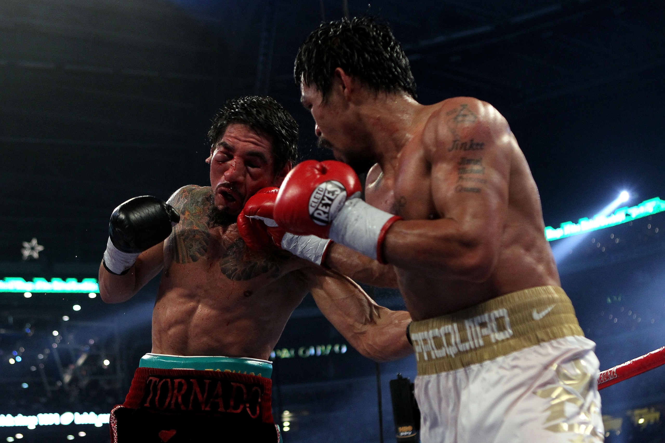 ARLINGTON, TX - NOVEMBER 13:  Manny Pacquiao (white trunks) of the Philippines lands a punch against Antonio Margarito (black trunks) of Mexico during their WBC World Super Welterweight Title bout at Cowboys Stadium on November 13, 2010 in Arlington, Texa