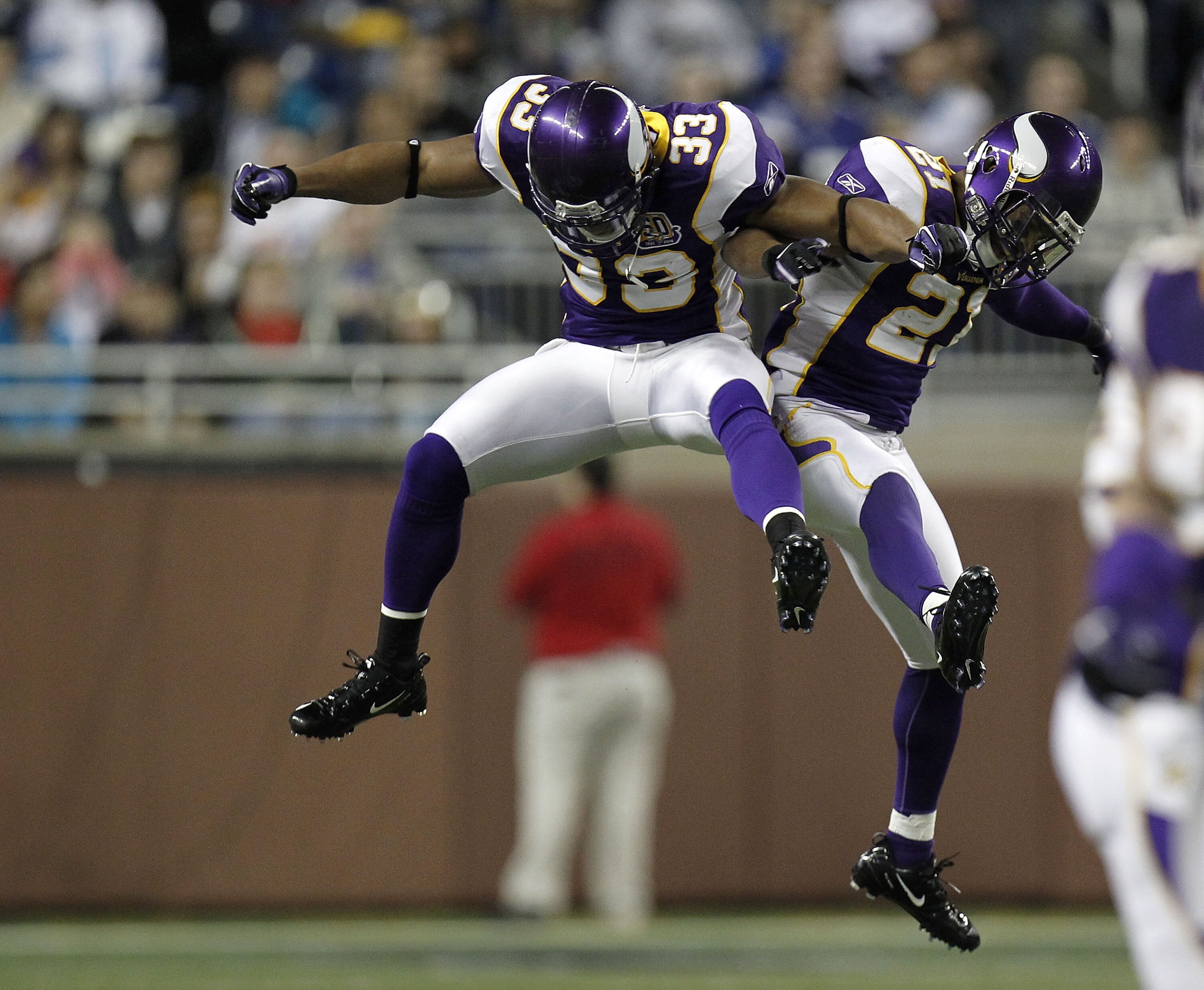 DETROIT, MI - DECEMBER 13:  Asher Allen #21 of the Minnesota Vikings celebrates a first quarter interception with Jamarca Sanford #33 while  playing the New York Giants at Ford Field on December 13, 2010 in Detroit, Michigan.  (Photo by Gregory Shamus/Get