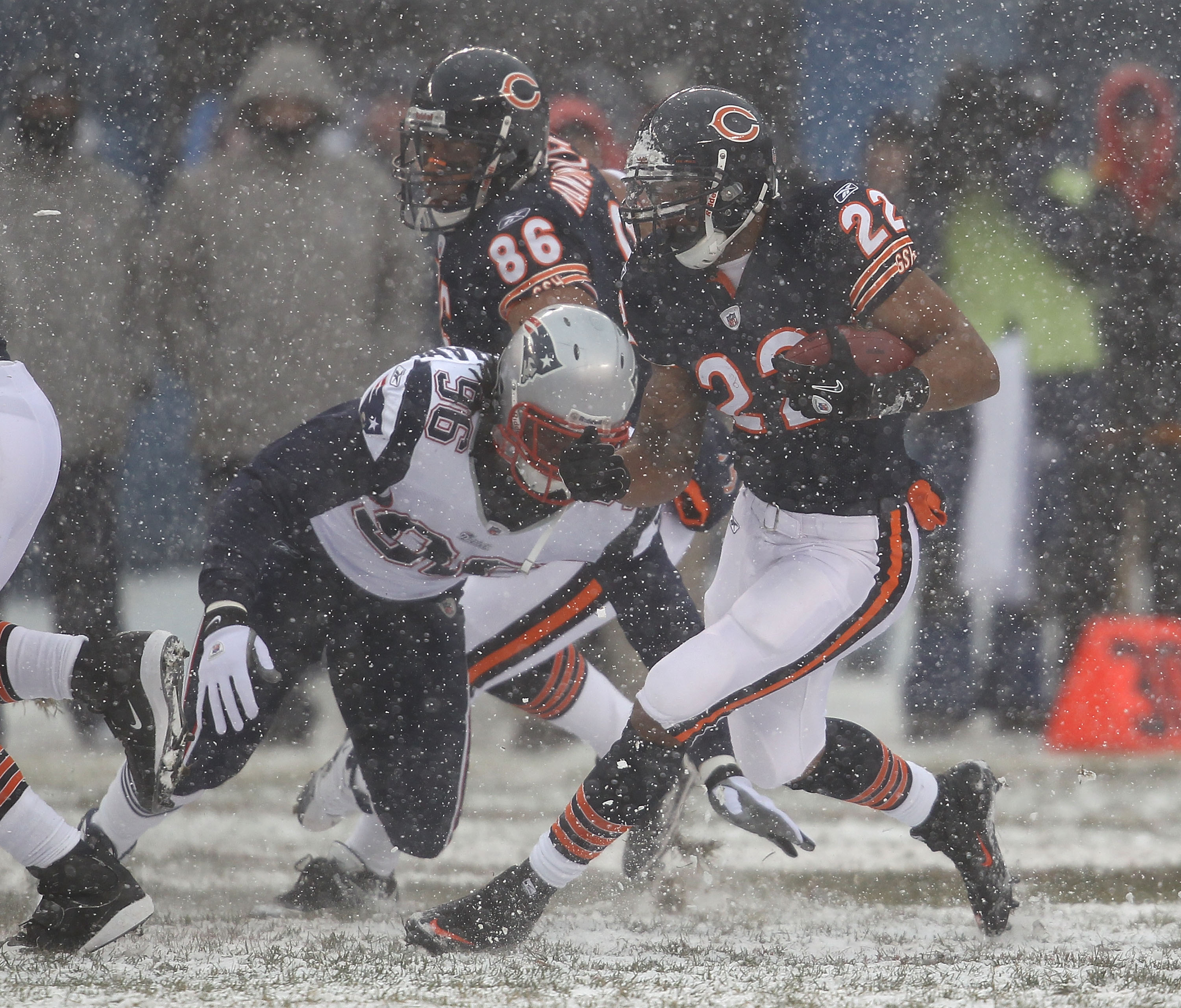 CHICAGO, IL - DECEMBER 12: Matt Forte #22 of the Chicago Bears avoids a tackle attempt by Jermaine Cunningham #96 of the New England Patriots at Soldier Field on December 12, 2010 in Chicago, Illinois. The Patriots defeated the Bears 36-7. (Photo by Jonat