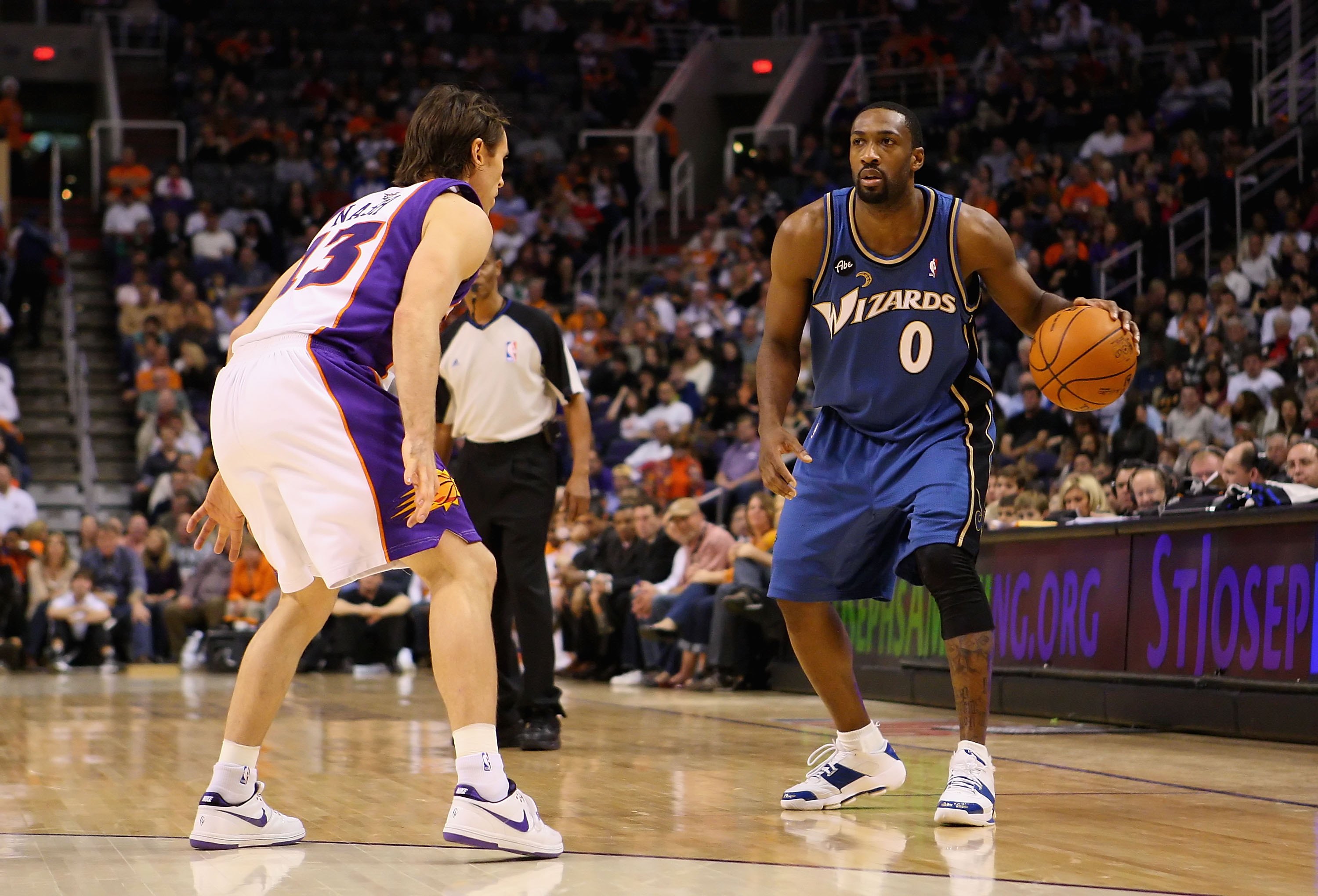 PHOENIX - DECEMBER 19:  Gilbert Arenas #0 of the Washington Wizards hanldles the ball during the NBA game against the Phoenix Suns at US Airways Center on December 19, 2009 in Phoenix, Arizona. The Suns defeated the Wizards 121-95. NOTE TO USER: User expr