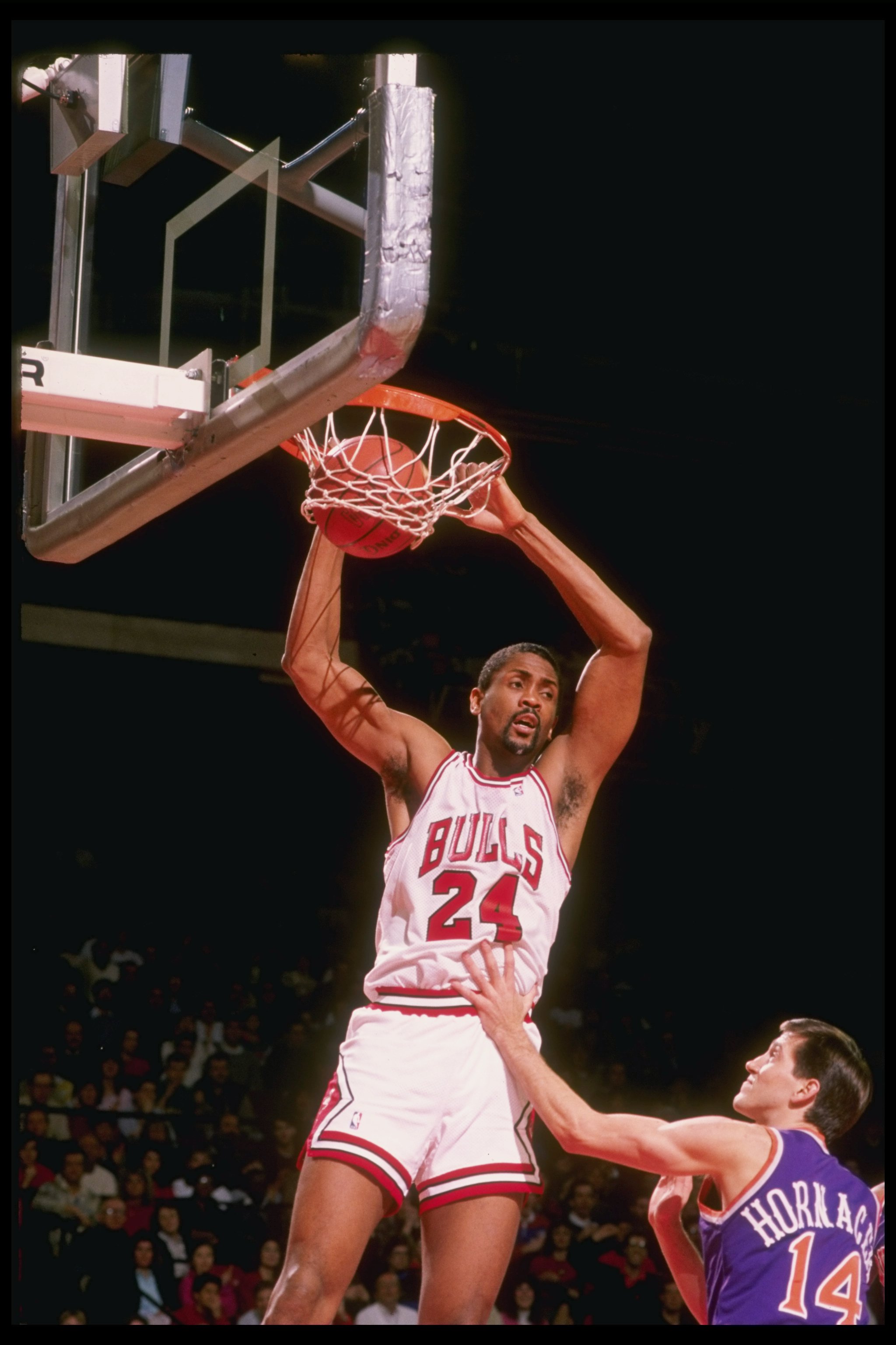 1990:  Center Bill Cartwright of the Chicago Bulls (left) slam dunks against guard Jeff Hornacek of the Phoenix Suns during a game at Chicago Stadium in Chicago, Illinois. Mandatory Credit: Jonathan Daniel  /Allsport