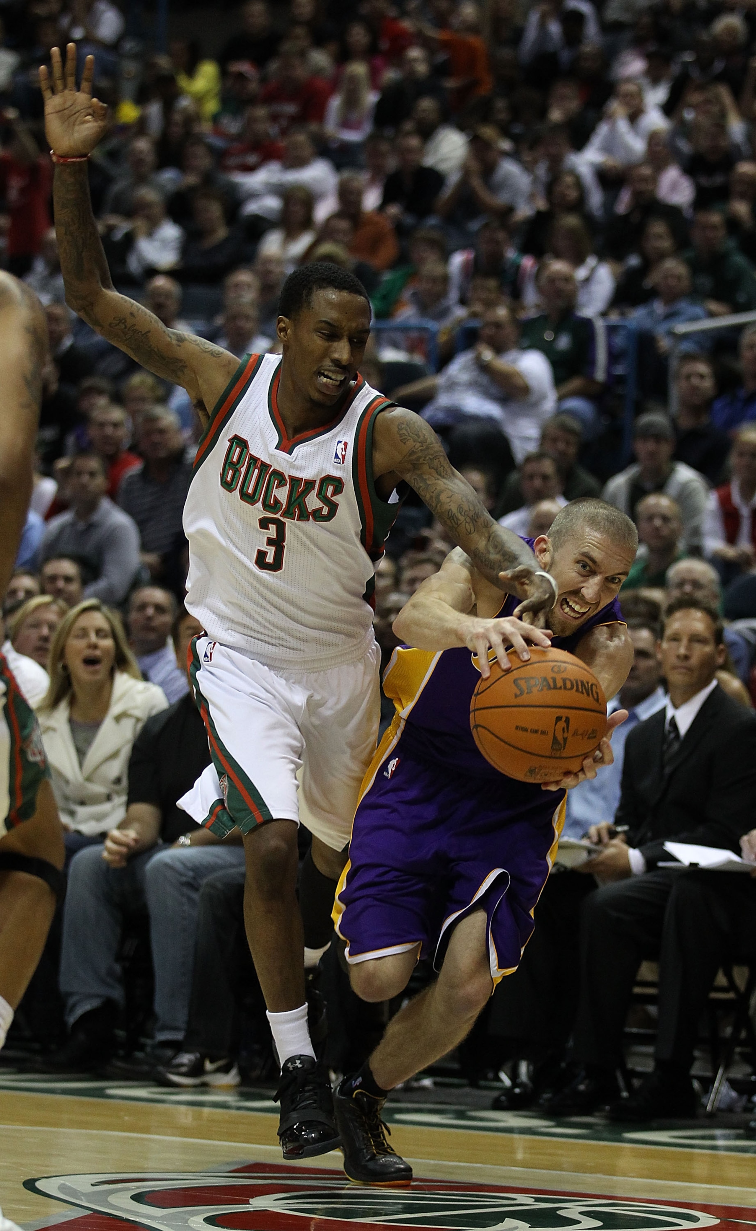 MILWAUKEE - NOVEMBER 16: Brandon Jennings #3 of the Milwaukee Bucks and Steve Blake #5 of the Los Angeles Lakers battle for a loose ball at the Bradley Center on November 16, 2010 in Milwaukee, Wisconsin. The Lakers defeated the Bucks 118-107. NOTE TO USE