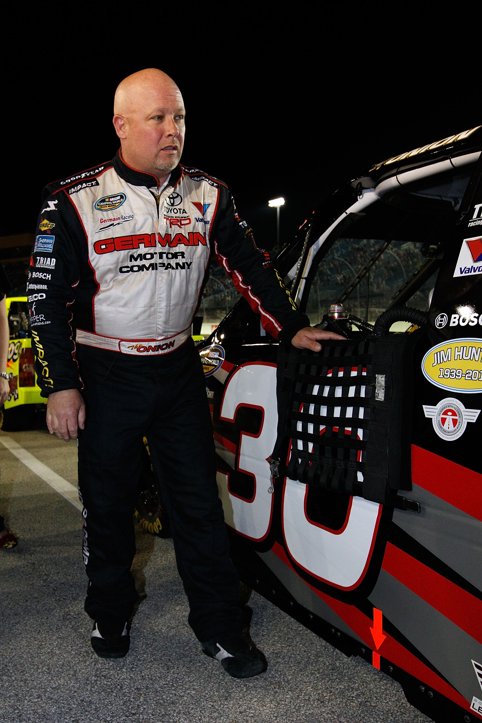 HOMESTEAD, FL - NOVEMBER 19:  Todd Bodine, driver of the #30 Germain Racing Toyota, stands on the starting grid prior to the NASCAR Camping World Truck Series Ford 200 at Homestead-Miami Speedway on November 19, 2010 in Homestead, Florida.  (Photo by Chri