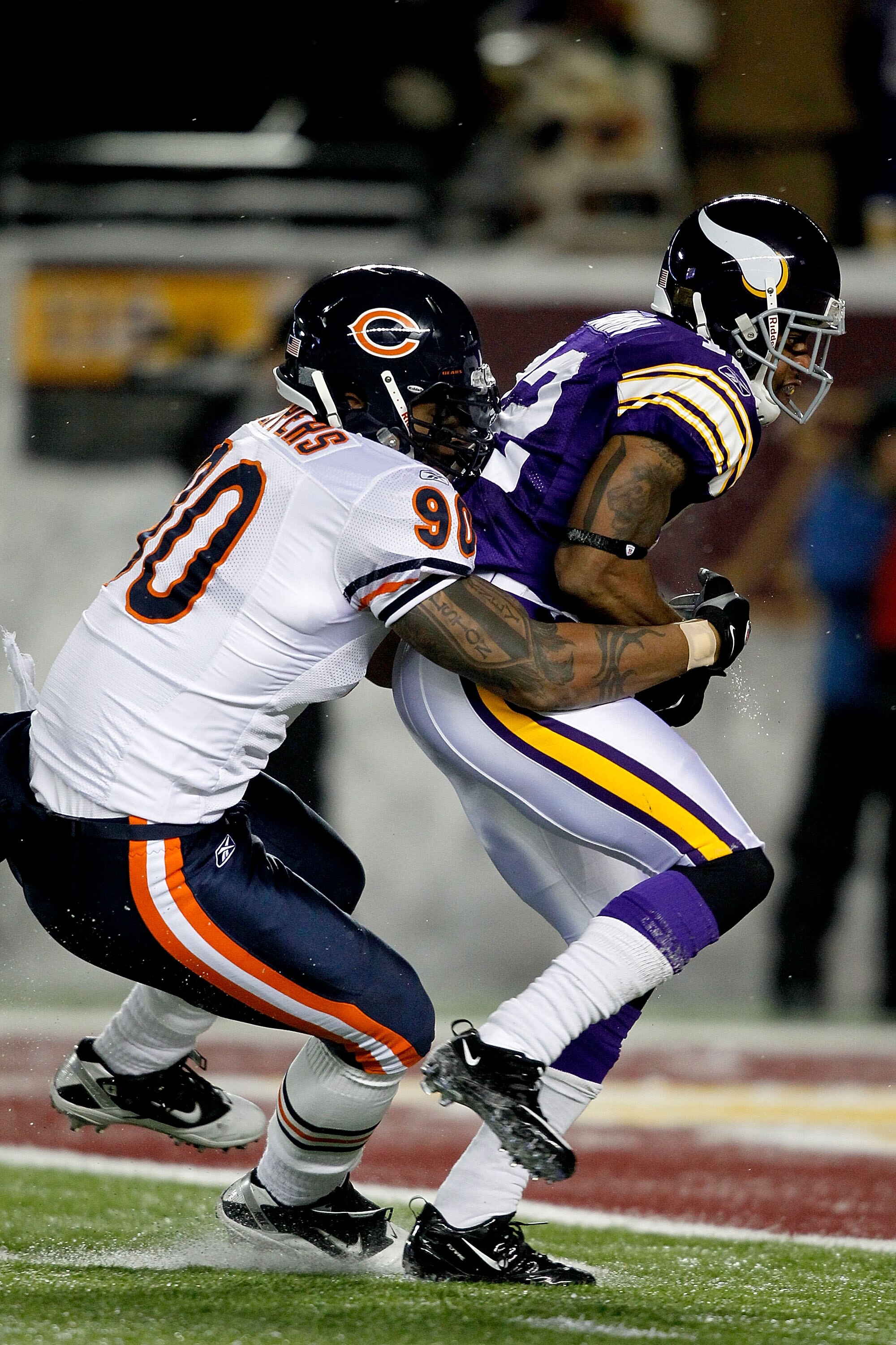 MINNEAPOLIS, MN - DECEMBER 20:  Percy Harvin #12 of the Minnesota Vikings of the Minnesota Vikings slips out of the grasp of Julius Peppers #90 of the Chicago Bears  for a touchdown at TCF Bank Stadium on December 20, 2010 in Minneapolis, Minnesota.  (Pho