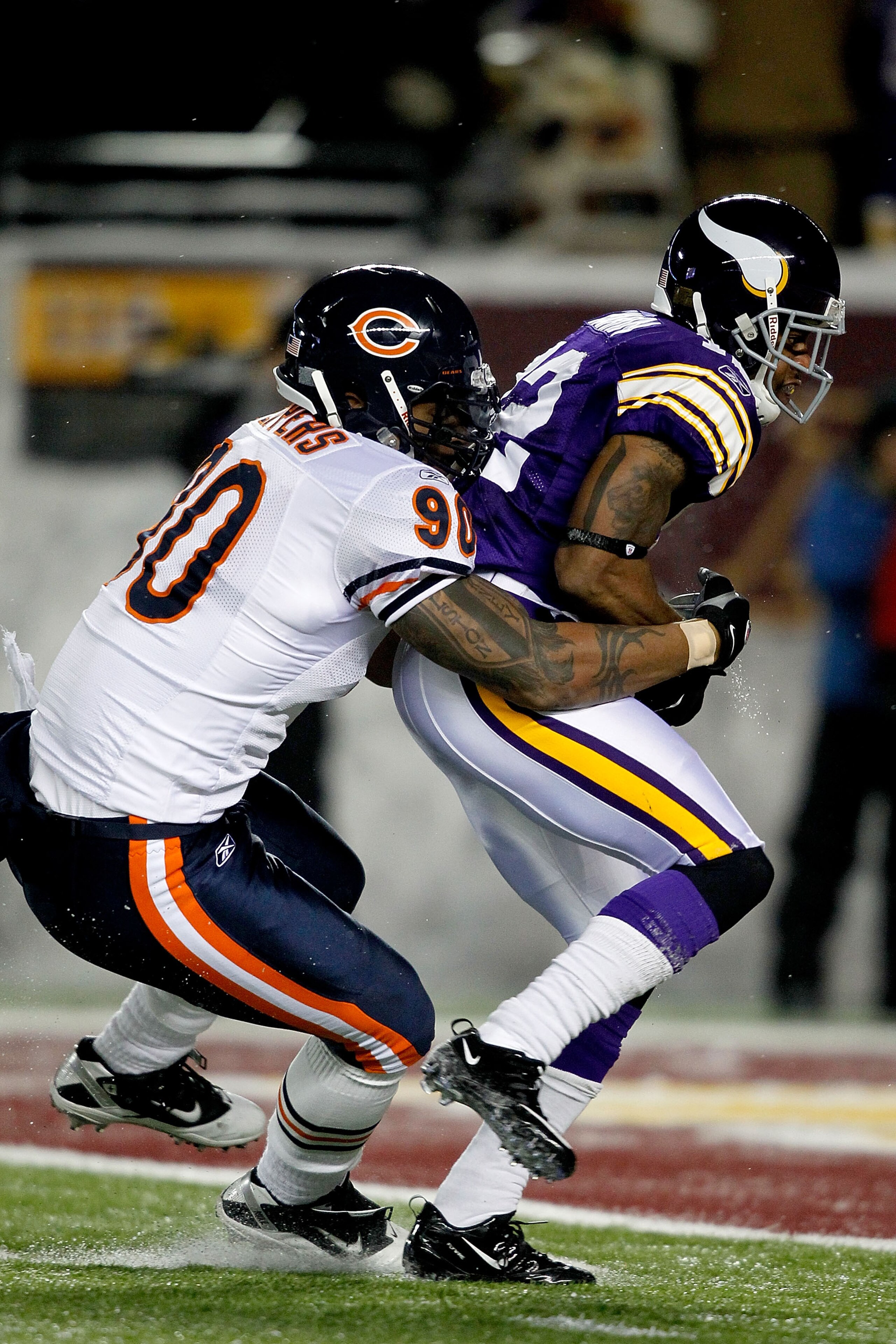 MINNEAPOLIS, MN - DECEMBER 20:  Percy Harvin #12 of the Minnesota Vikings of the Minnesota Vikings slips out of the grasp of Julius Peppers #90 of the Chicago Bears  for a touchdown at TCF Bank Stadium on December 20, 2010 in Minneapolis, Minnesota.  (Pho