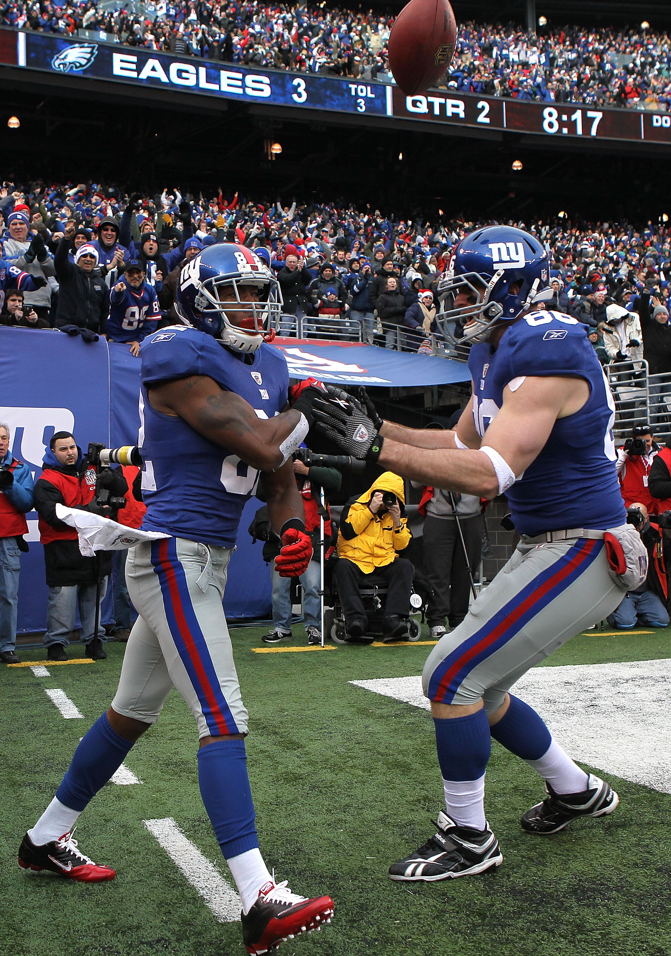 EAST RUTHERFORD, NJ - DECEMBER 19:  Mario Manningham #82 of the New York Giants celebrates his touchdown with teammate Bear Pascoe #86 against the Philadelphia Eagles at New Meadowlands Stadium on December 19, 2010 in East Rutherford, New Jersey.  (Photo