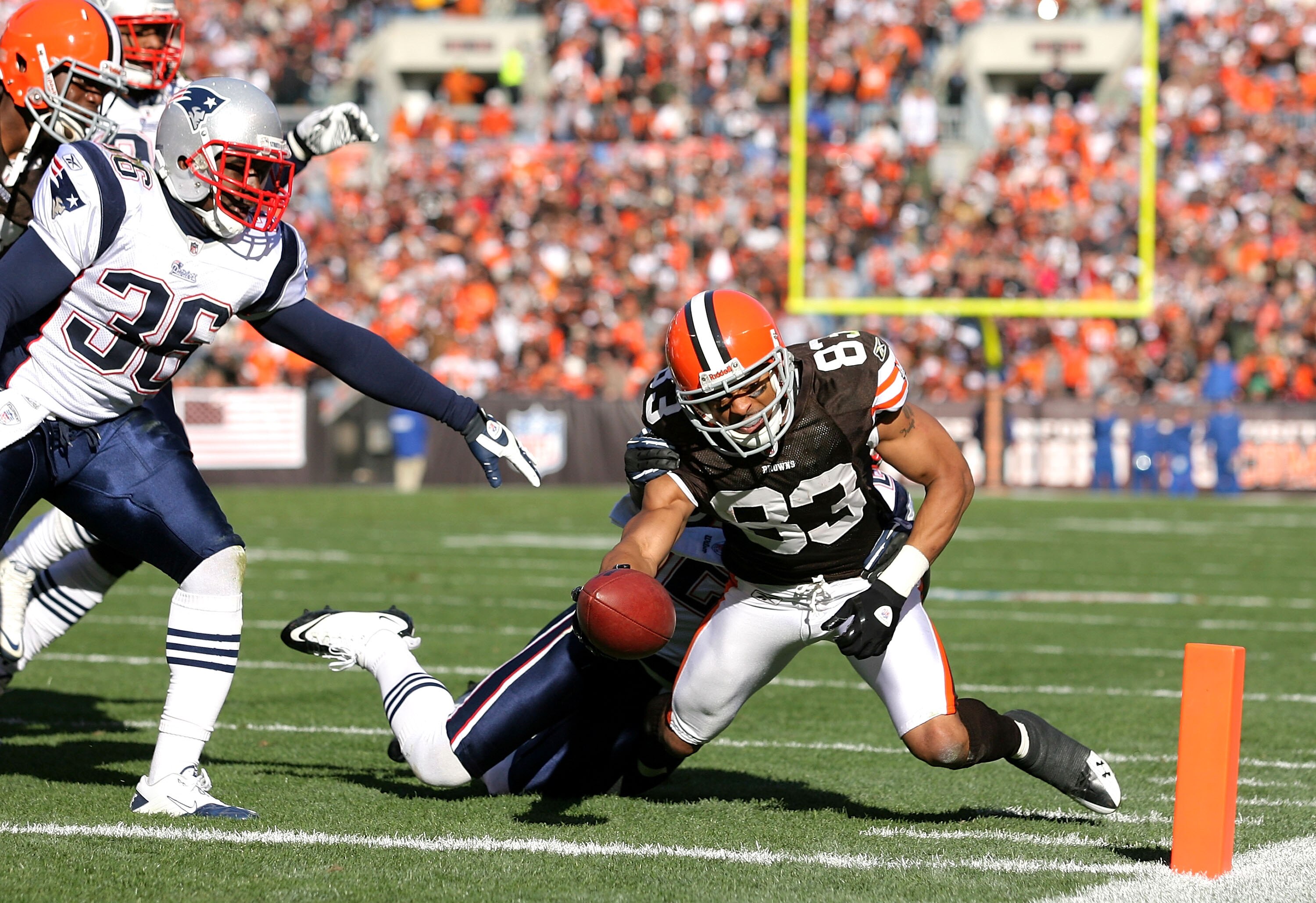 CLEVELAND - NOVEMBER 07: Wide receiver Chansi Stuckey #83 of the Cleveland Browns scores a touchdown in front of defenders James Sanders #36 and Kyle Arrington #27 of the New England Patriots at Cleveland Browns Stadium on November 7, 2010 in Cleveland, O