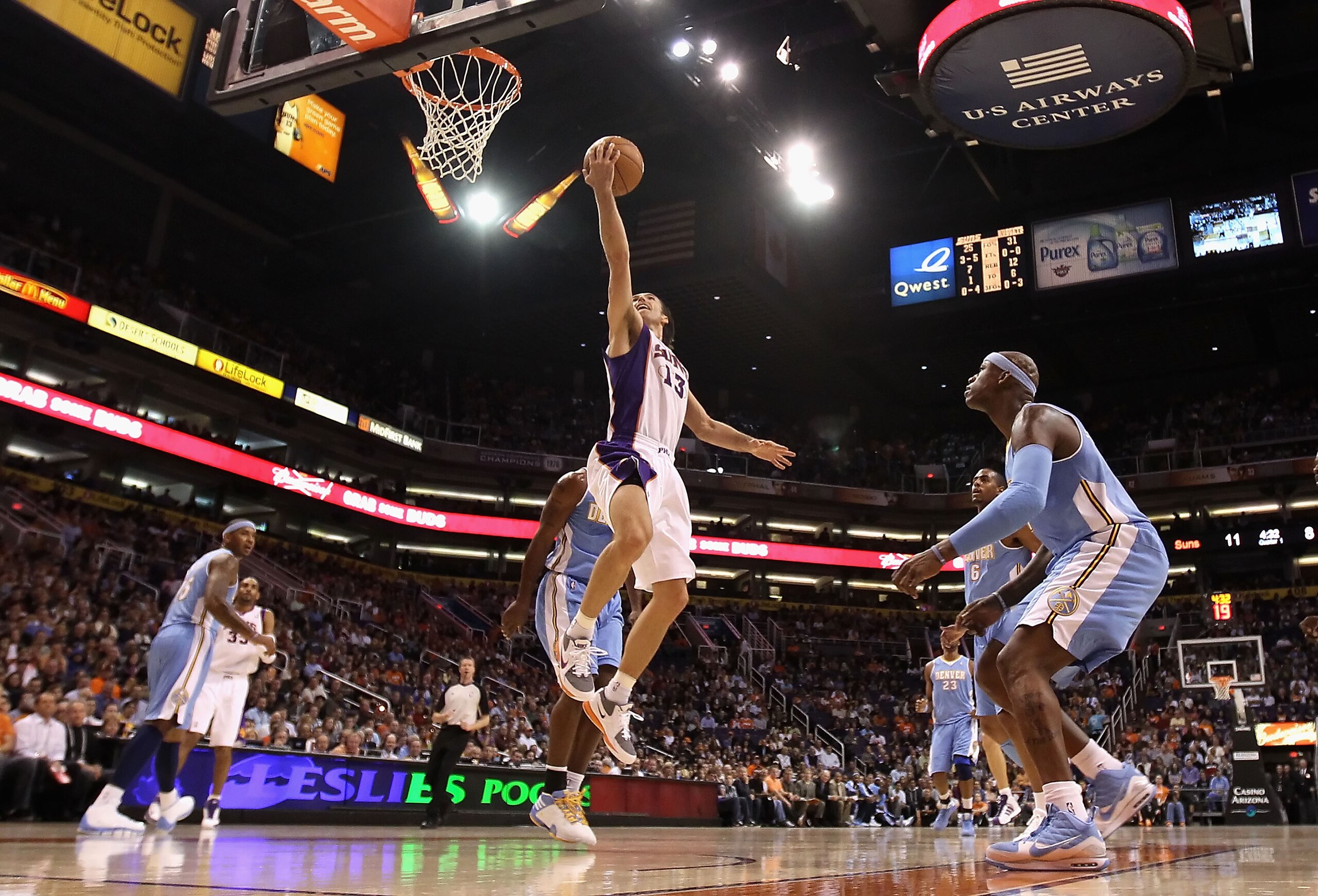 PHOENIX - NOVEMBER 15:  Steve Nash #13 of the Phoenix Suns lays up a shot against the Denver Nuggets during the NBA game at US Airways Center on November 15, 2010 in Phoenix, Arizona. The Suns defeated the Nuggets 100-94.  NOTE TO USER: User expressly ack