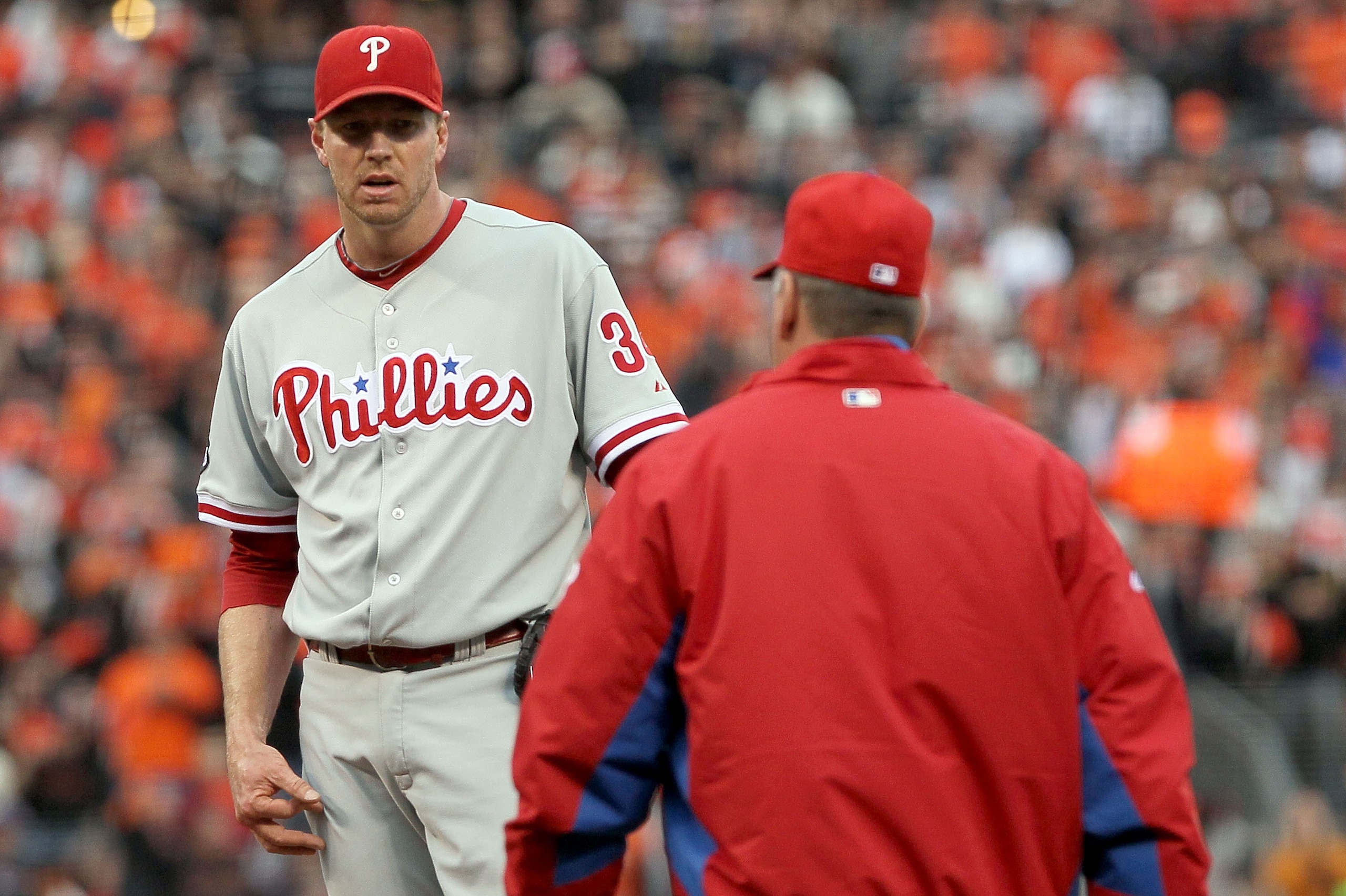 SAN FRANCISCO - OCTOBER 21:  (R-L) Pitching coach Rich Dubee of the Philadelphia Phillies heads to the mound to speak with Roy Halladay #34 in the first inning of Game Five of the NLCS against the San Francisco Giants during the 2010 MLB Playoffs at AT&T