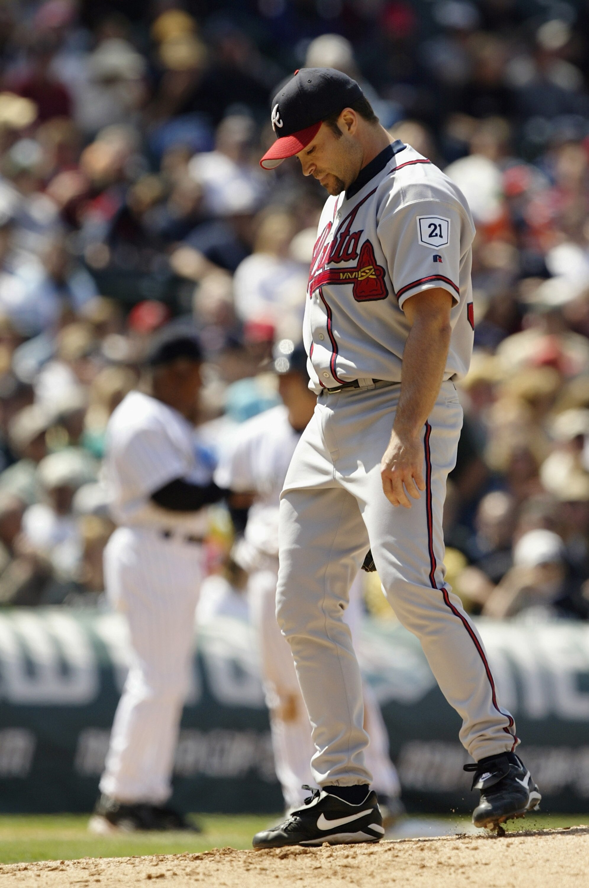 DENVER - MAY 1:  Starter Mike Hampton #32 of the Atlanta Braves kicks at the mound after walking Vinny Castilla of the Colorado Rockies with the bases loaded to tie the game 2-2 in the fifth inning at Coors Field on May 1, 2004 in Denver, Colorado.  The R