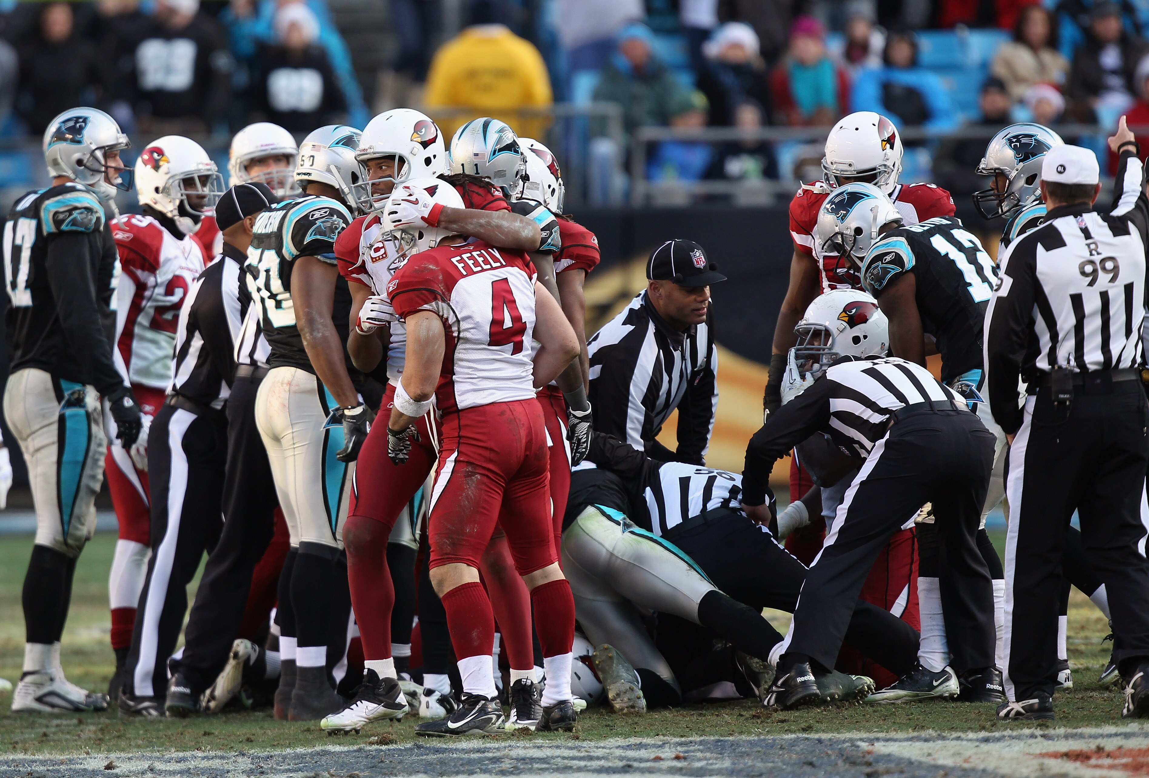 CHARLOTTE, NC - DECEMBER 19:  Larry Fitzgerald #11 of the Arizona Cardinals checks in on teammate Jay Feely #4 after an onside kick during their game against the Carolina Panthers at Bank of America Stadium on December 19, 2010 in Charlotte, North Carolin