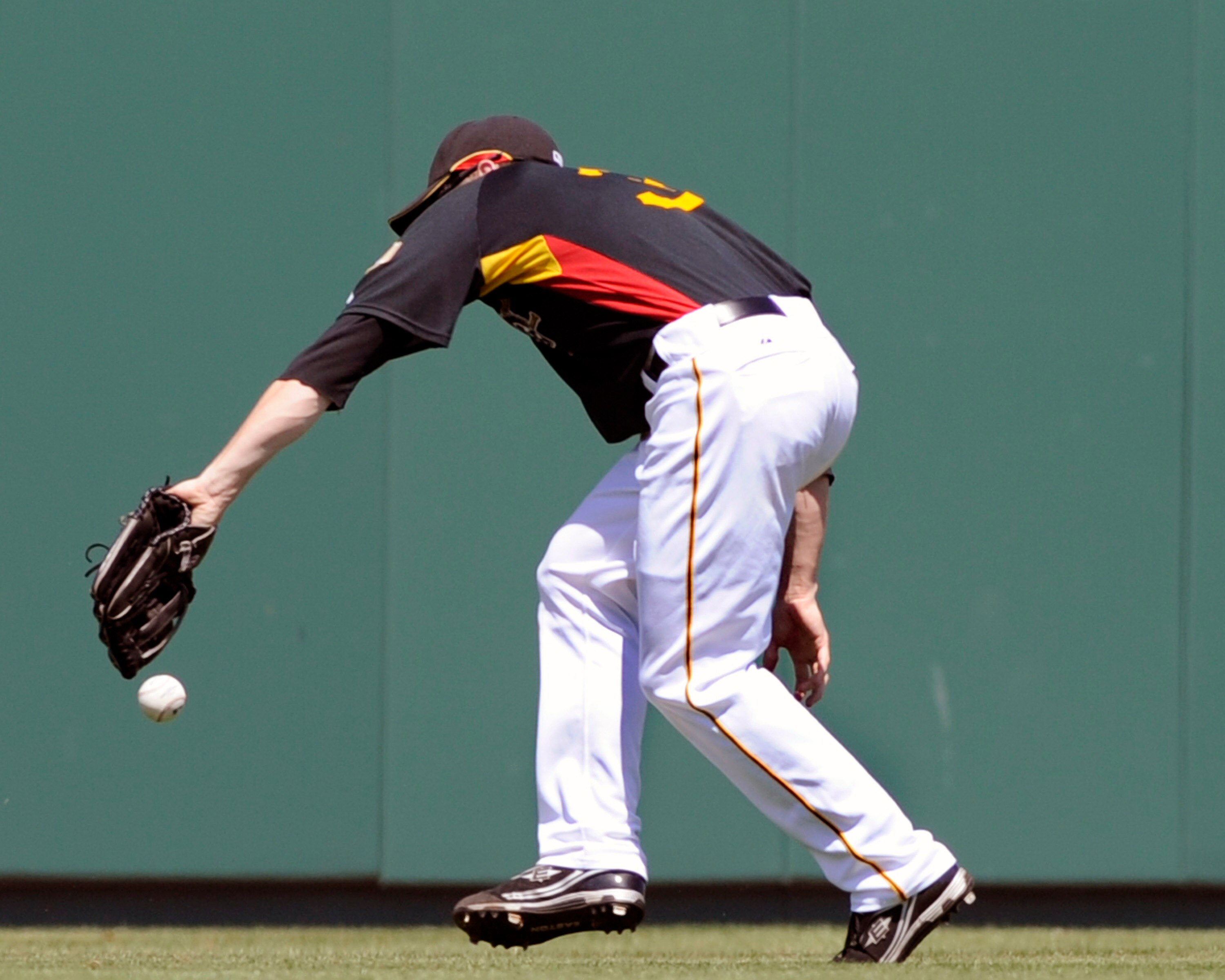 BRADENTON, FL - MARCH 21: Outfielder Jason Bay #38 of the Pittsburgh Pirates misses a wind-blown fly ball against the Cincinnati Reds March 21, 2008 at McKechnie Field in Bradenton, Florida. Bay was charged with an error. (Photo by Al Messerschmidt/Getty