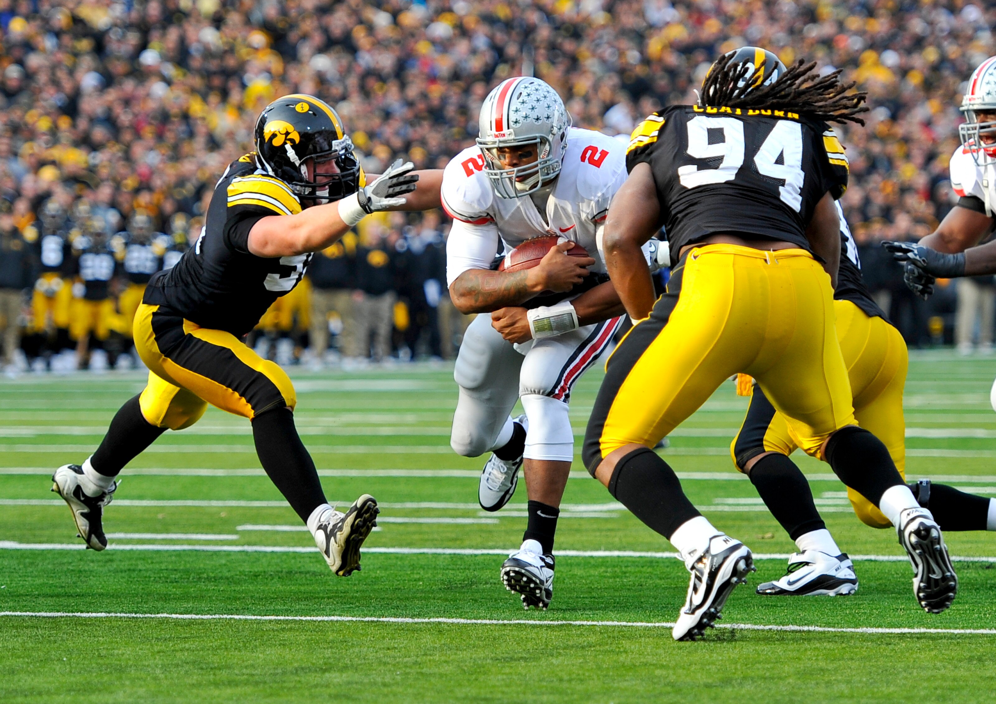 IOWA CITY, IA - NOVEMBER 20: Defeisive linemen Karl Klug #95 and Adrian Clayborn #94 of the University of Iowa Hawkeyes close in for the tackle on quarterback Terrelle Pryor #2 of the Ohio State Buckeyes as he drive the ball towards the goal line during t