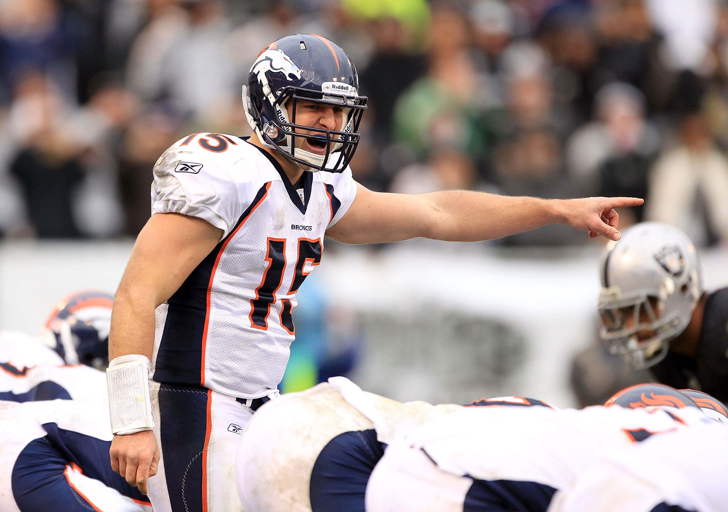 OAKLAND, CA - DECEMBER 19:  Tim Tebow #15 of the Denver Broncos shouts instructions to his team during their game against the Oakland Raiders at Oakland-Alameda County Coliseum on December 19, 2010 in Oakland, California.  (Photo by Ezra Shaw/Getty Images