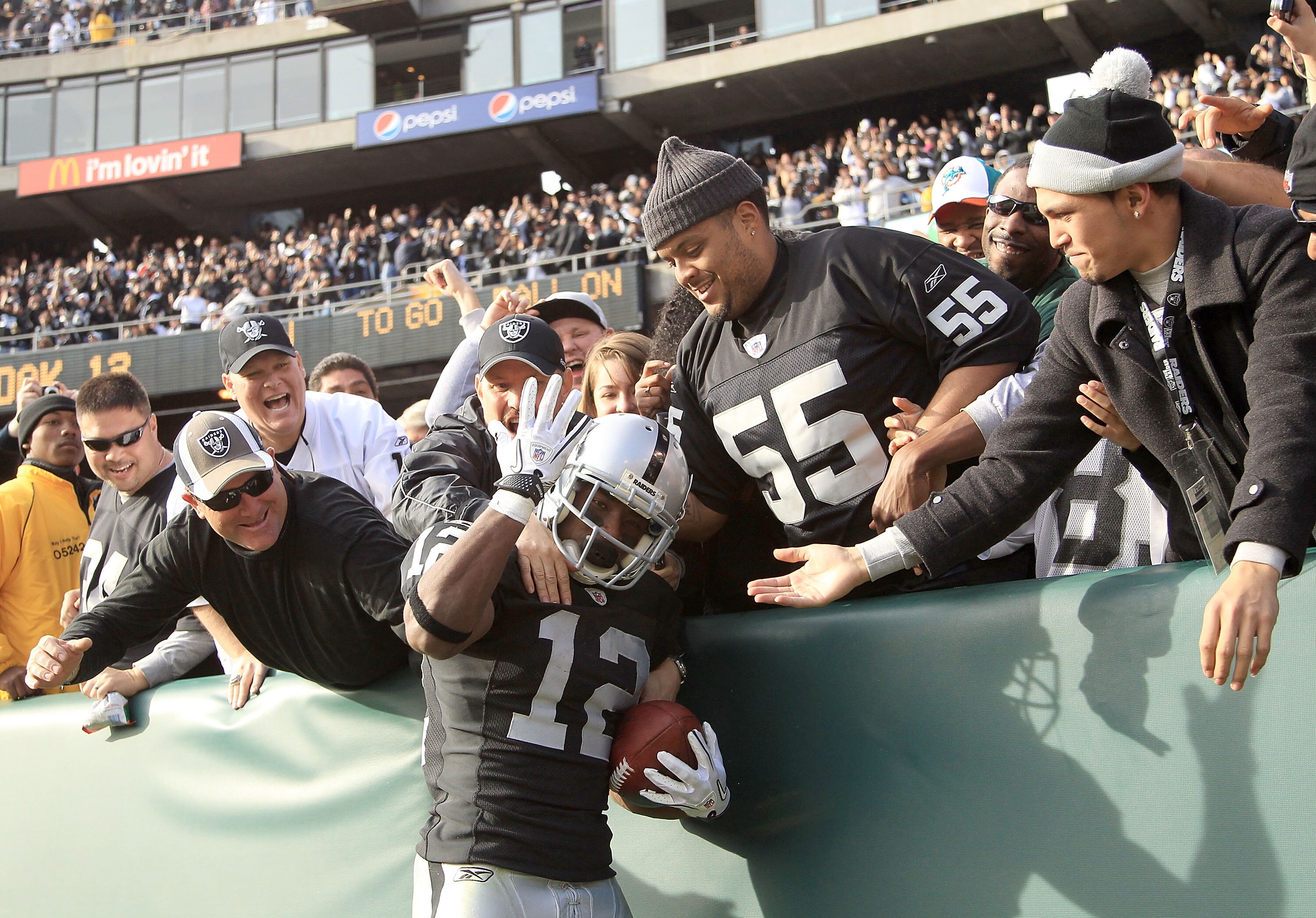 OAKLAND, CA - NOVEMBER 28:  Jacoby Ford #12 of the Oakland Raiders is congratulated by fans after he scored a touchdown against the Miami Dolphins at Oakland-Alameda County Coliseum on November 28, 2010 in Oakland, California.  (Photo by Ezra Shaw/Getty I