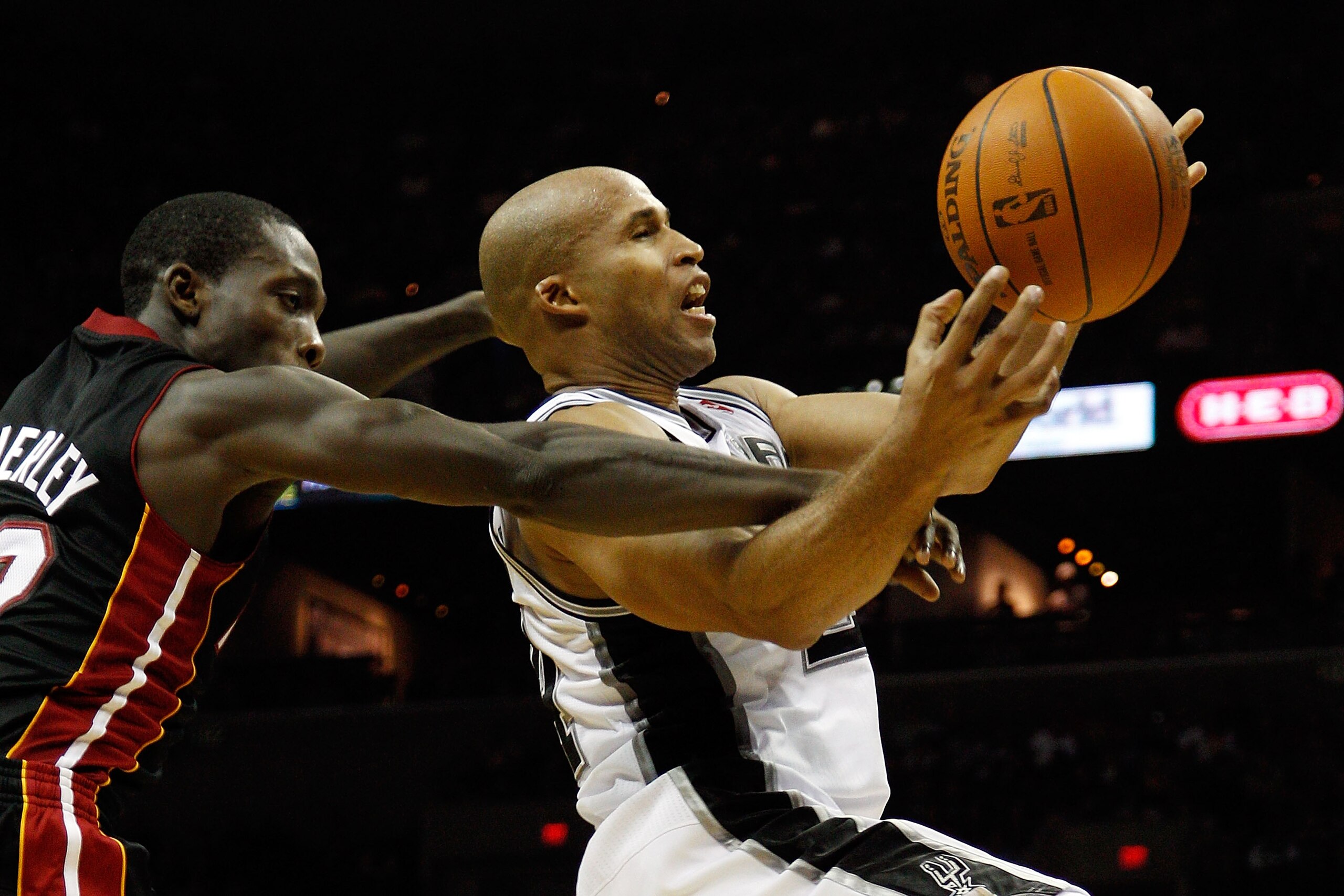 SAN ANTONIO - OCTOBER 09:  Richard Jefferson #24 of the San Antonio Spurs is fouled by Patrick Beverley #12 of the Miami Heat at the AT&T Center on October 9, 2010 in San Antonio, Texas.  NOTE TO USER: User expressly acknowledges and agrees that, by downl