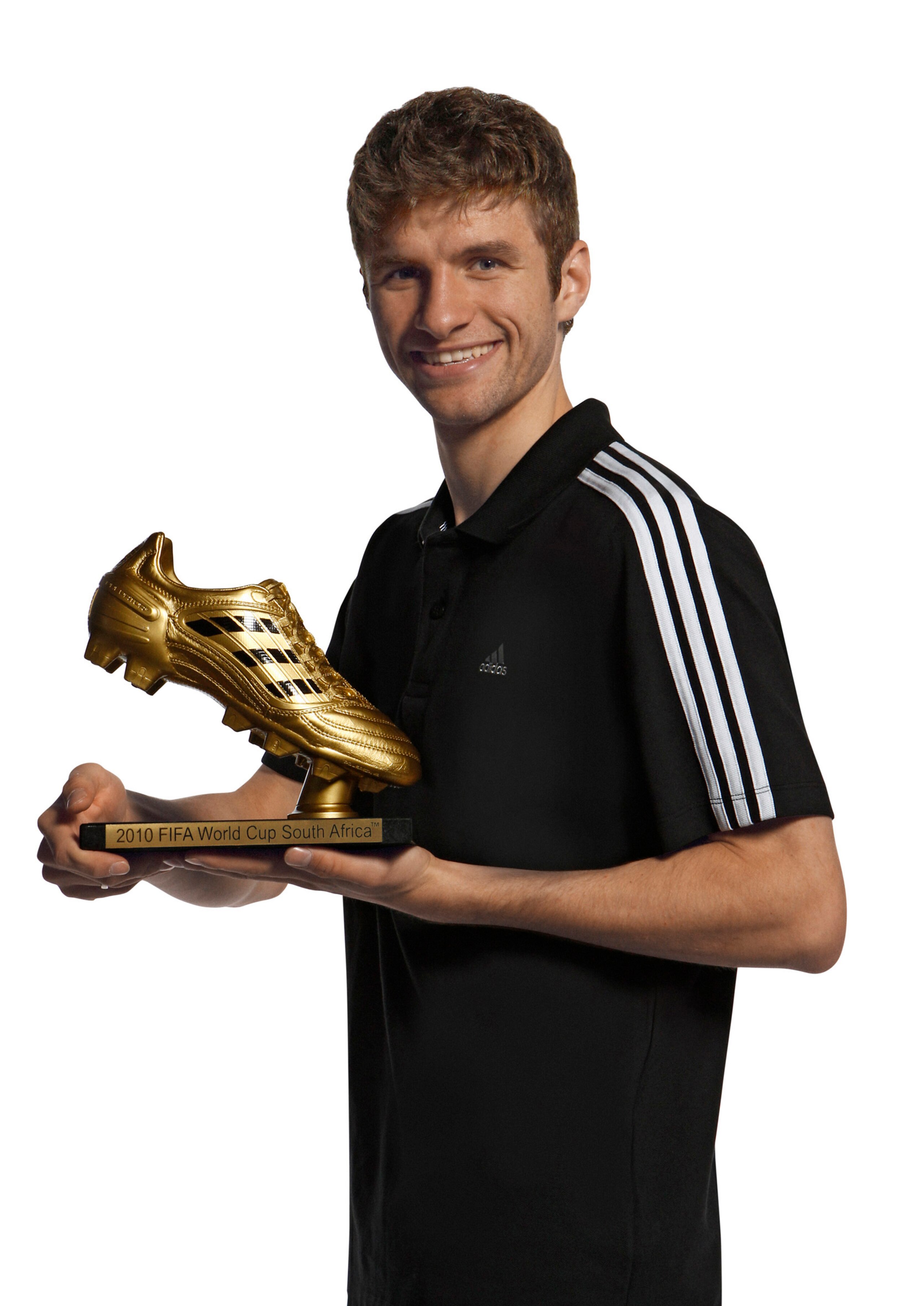 HERZOGENAURACH, GERMANY - DECEMBER 14:  Thomas Mueller of Germany poses with the adidas Golden Boot Winner Trophy at the adidas HQ on December 14, 2010 in Herzogenaurach, Germany. (Photo by Getty Images for adidas)