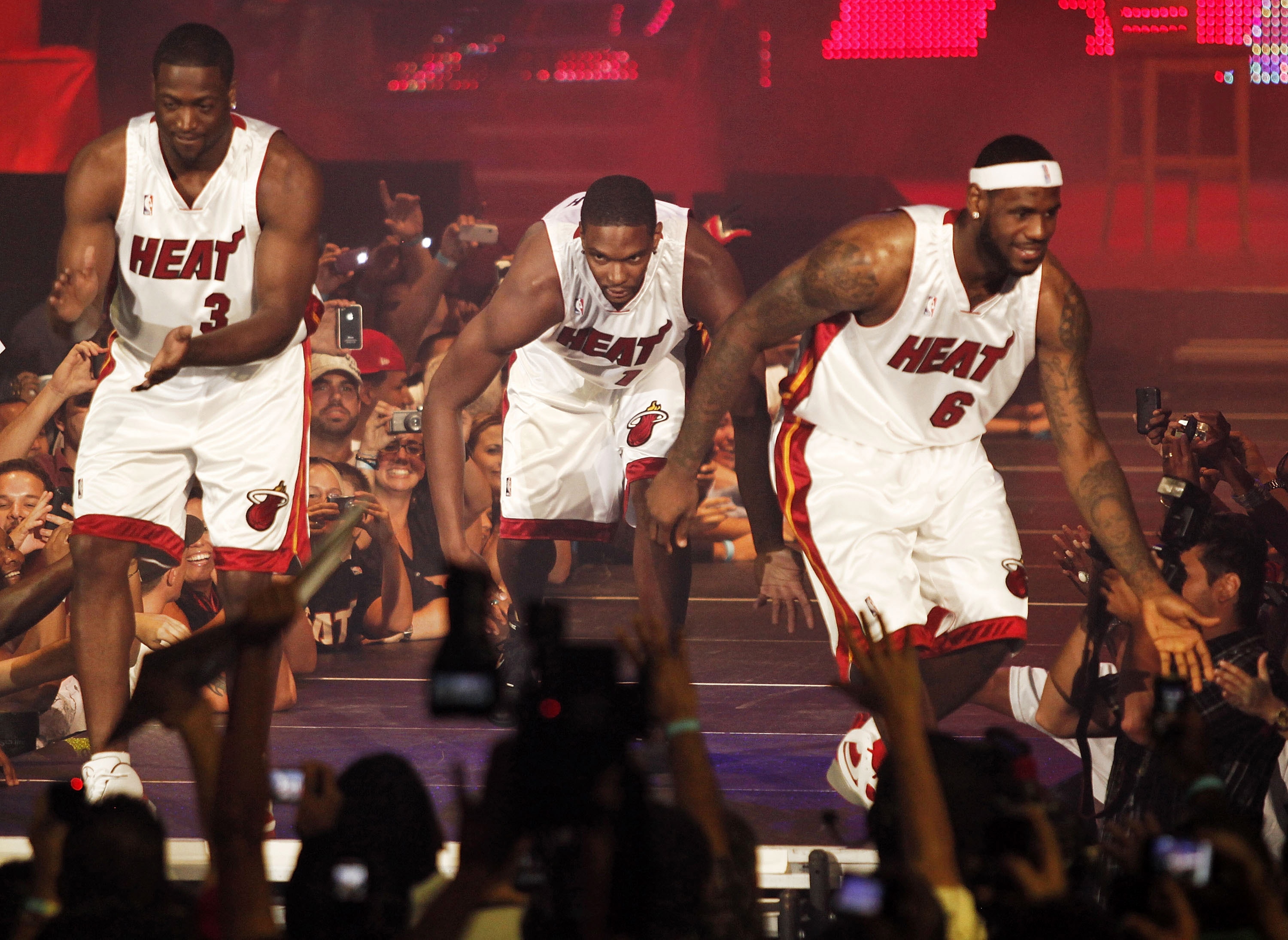 MIAMI - JULY 09:  Fans cheer as (L-R) Dwyane Wade #3, Chris Bosh #1 and LeBron James #6 of the Miami Heat are introduced during a welcome party at American Airlines Arena on July 9, 2010 in Miami, Florida.  (Photo by Marc Serota/Getty Images)