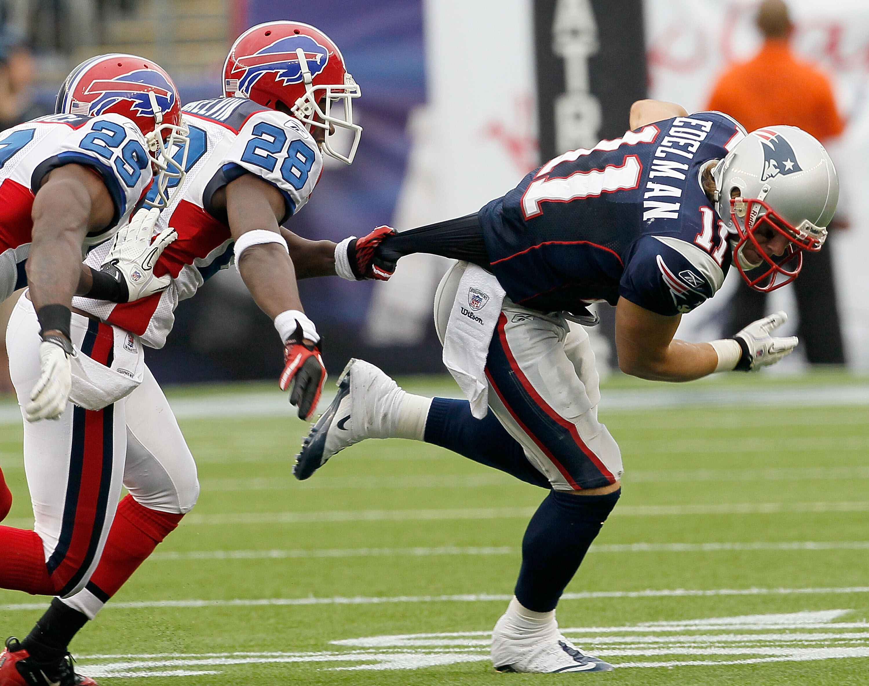 FOXBORO, MA - SEPTEMBER 26:  Julian Edelman #11 of the New England Patriots gains yards as defenders Drayton Florence #29 and Leodis McKelvin #28 of the Buffalo Bills give chase in the second half at Gillette Stadium on September 26, 2010 in Foxboro, Mass
