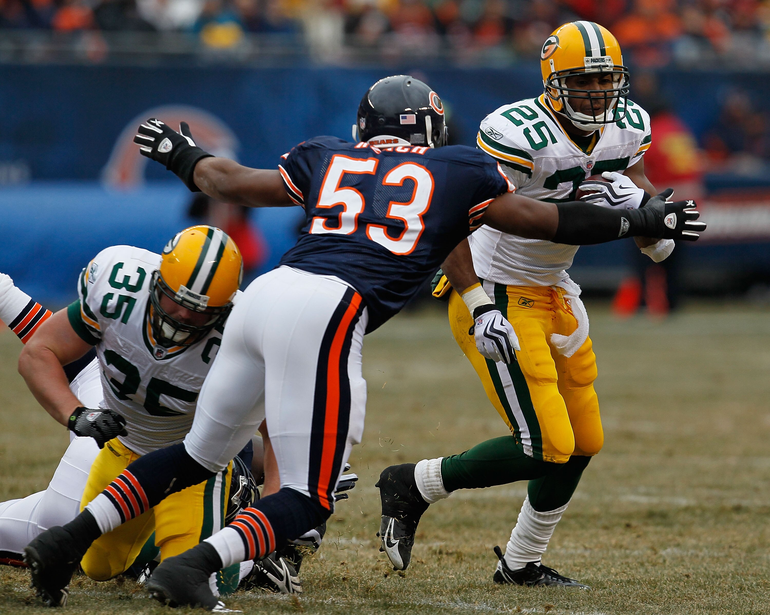 CHICAGO - DECEMBER 13: Nick Roach #53 of the Chicago Bears moves to tackle Ryan Grant #25 of the Green Bay Packers after playing off a block attempt by Korey Hall #35 at Soldier Field on December 13, 2009 in Chicago, Illinois. (Photo by Jonathan Daniel/Ge