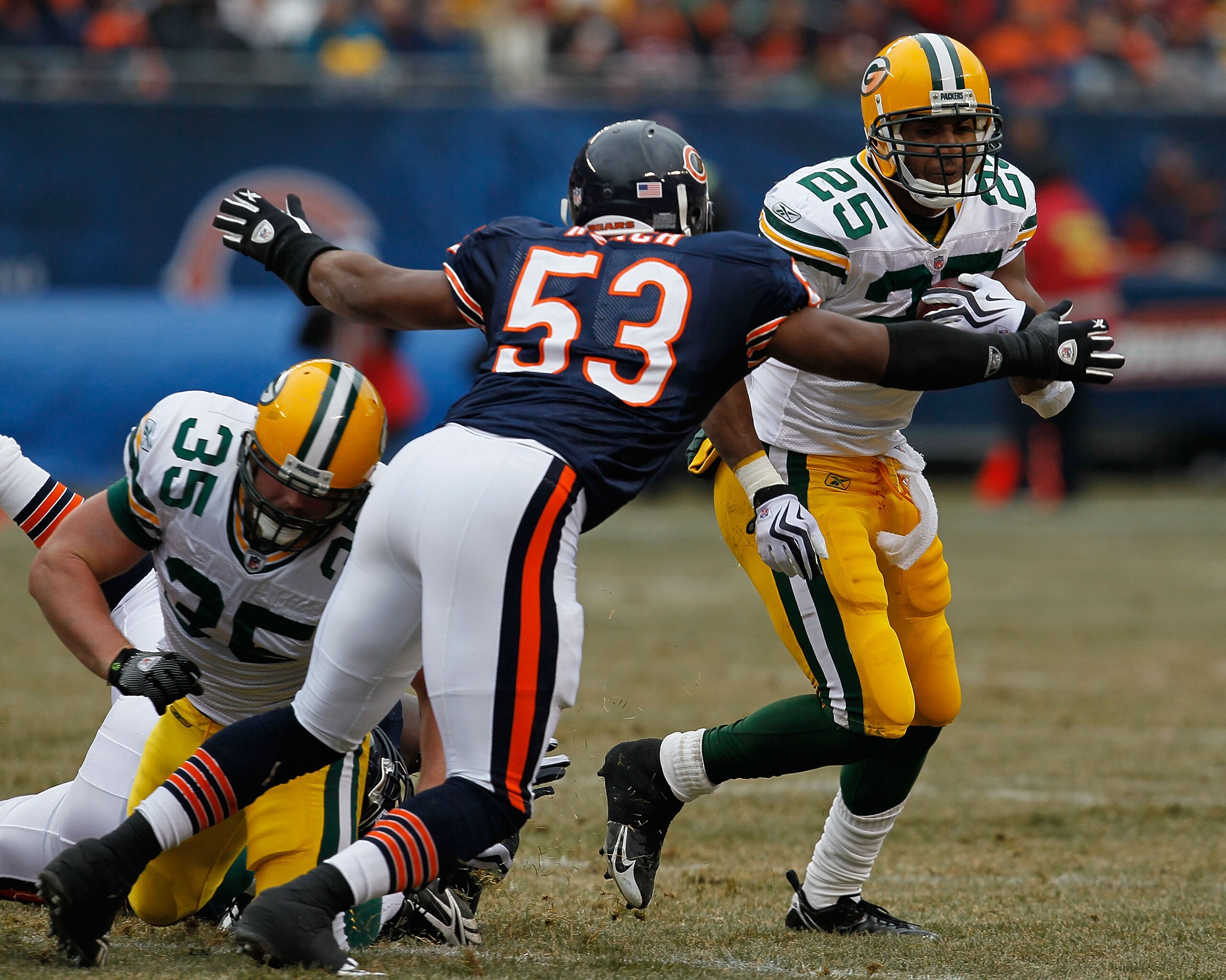CHICAGO - DECEMBER 13: Nick Roach #53 of the Chicago Bears moves to tackle Ryan Grant #25 of the Green Bay Packers after playing off a block attempt by Korey Hall #35 at Soldier Field on December 13, 2009 in Chicago, Illinois. (Photo by Jonathan Daniel/Ge