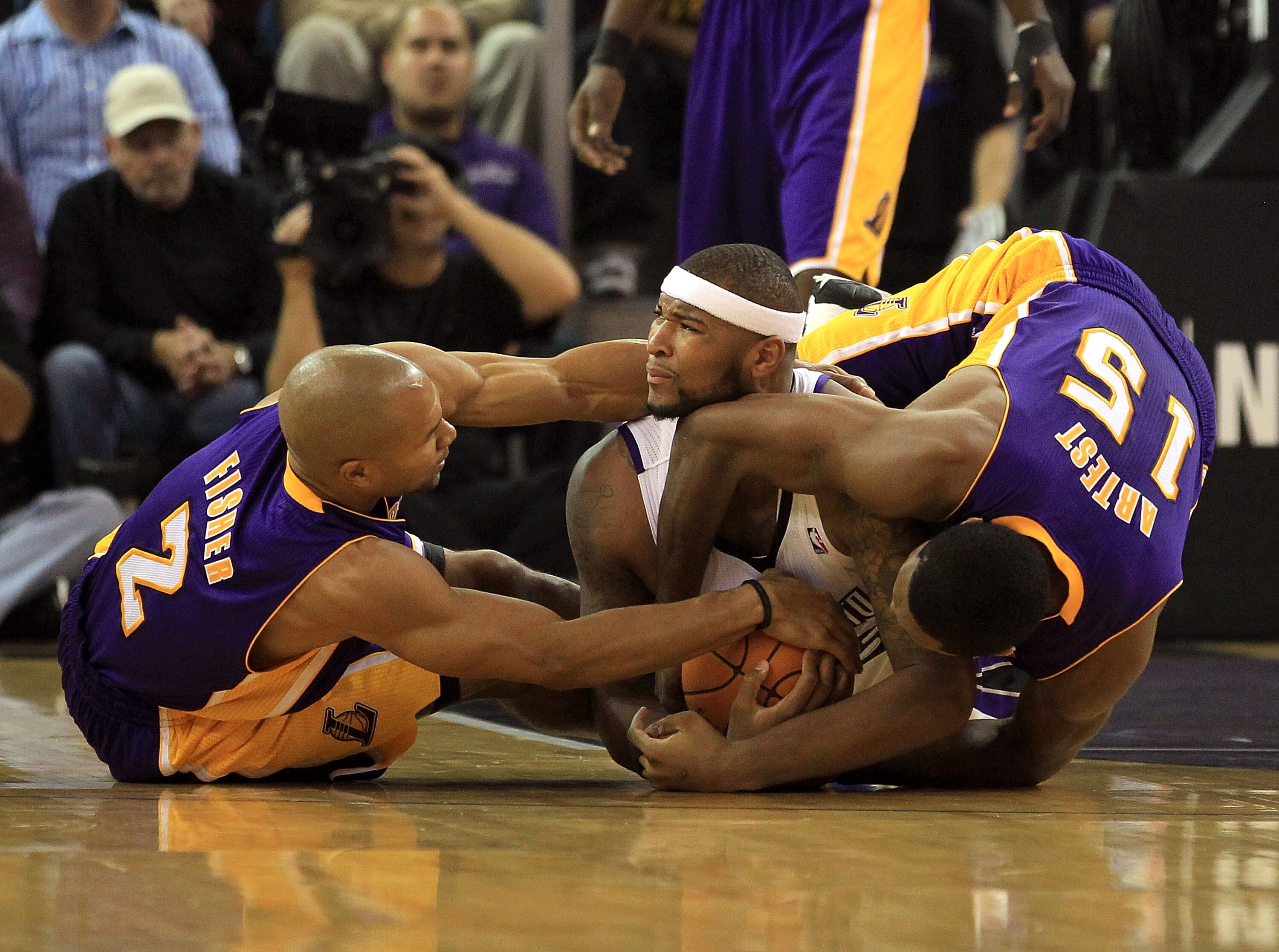 SACRAMENTO, CA - NOVEMBER 03: Derek Fisher #2 and Ron Artest #15 of the Los Angeles Lakers wrestle for the ball with DeMarcus Cousins #15 of the Sacramento Kings at ARCO Arena on November 3, 2010 in Sacramento, California. NOTE TO USER: User expressly a SACRAMENTO, CA - NOVEMBER 03: Derek Fisher #2 and Ron Artest #15 of the Los Angeles Lakers wrestle for the ball with DeMarcus Cousins #15 of the Sacramento Kings at ARCO Arena on November 3, 2010 in Sacramento, California. NOTE TO USER: User expressly a