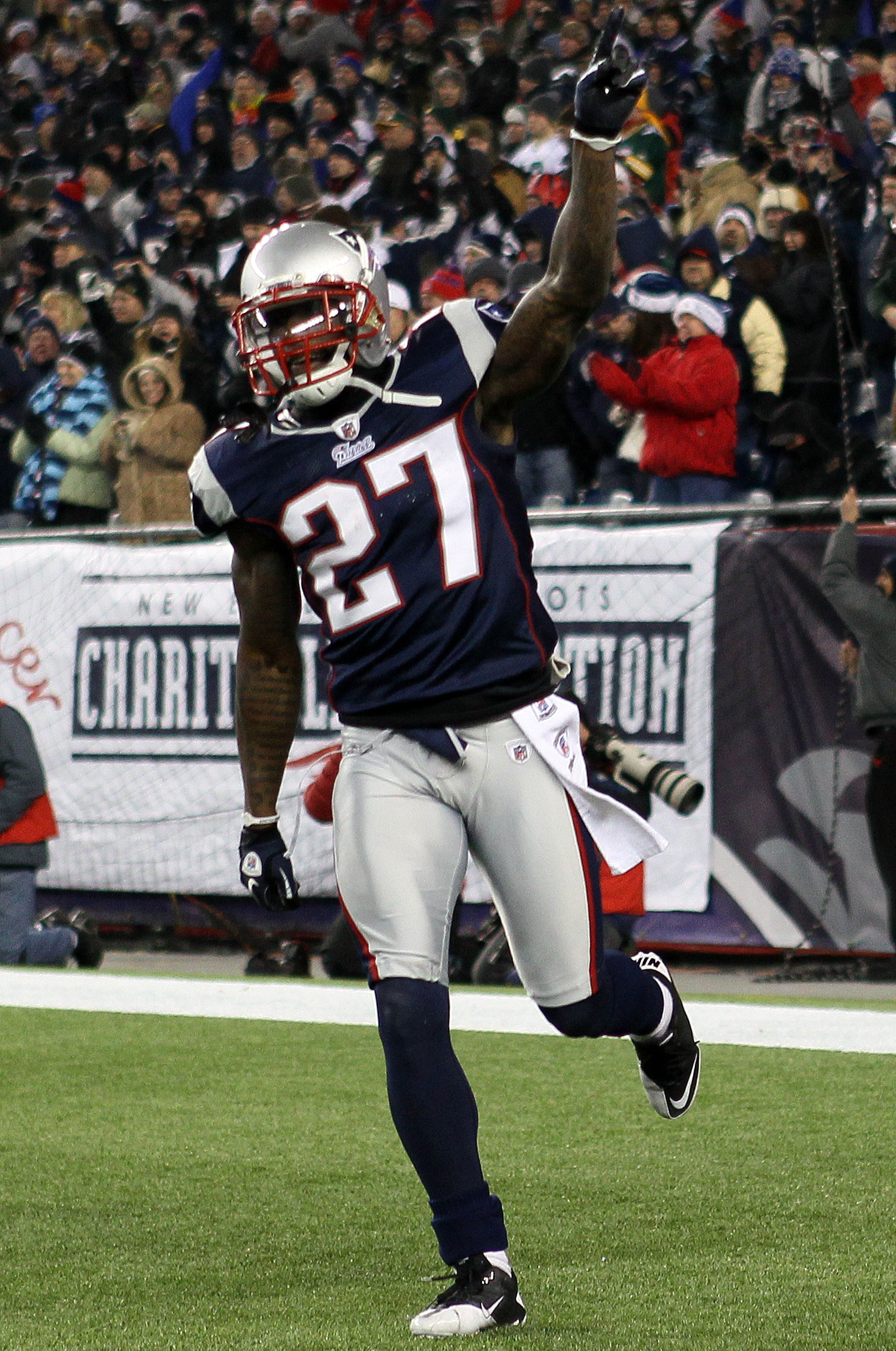 FOXBORO, MA - DECEMBER 19:  Cornerback Kyle Arrington #27 of the New England Patriots celebrates scoring a touchdown after intercepting the ball and running 36 yards against the Green Bay Packers during the third quarter of the game at Gillette Stadium on
